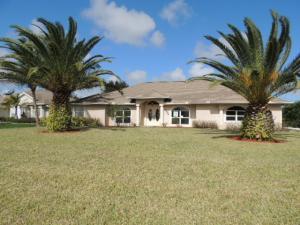 Enjoy this wonderful oversize corner lot screened enclosed pool home. This home backs up to drainage canal with rear white picket fence. Home features wood burning fireplace in family room, tile floors through mainly living area, laminate and carpeted bedrooms. Kitchen has nice wood cabinets, eat-in area, and cabana bath to pool patio with exterior bar. This home has an open and bright layout with formal sitting dining, eat-in area and family room. Double French doors and sliding glass door leads to pool patio from master bed, rear bedroom and living area. Exterior yard has lush mature landscape with brick paver driveway. This is a Fannie Mae Homepath property.
