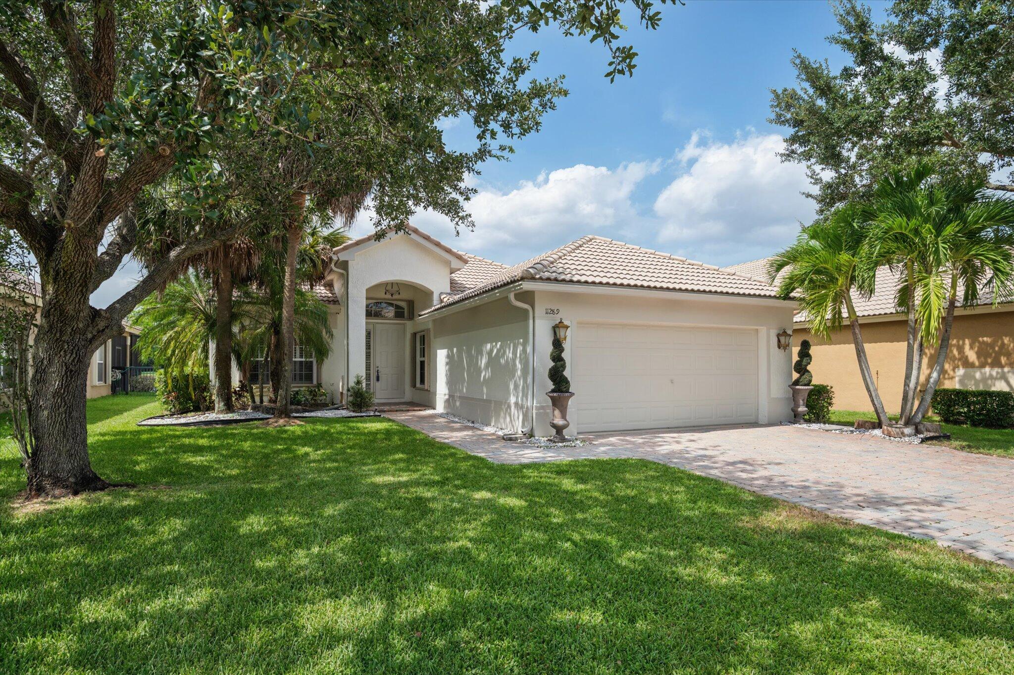 Enjoy breathtaking long lake views from this beautifully maintained 3-bedroom, 2-bath home in the highly sought-after gated community of Parkland Isles. Offering approximately 2,000 sq. ft. of living space, this home features an open floor plan with high ceilings, crown molding, plantation shutters, French doors, and a split-bedroom layout. The spacious primary suite overlooks the lake and offers dual sinks, a separate shower, and a Whirlpool soaking tub. The remodeled secondary bath adds a stylish touch. The kitchen opens to the screened brick-paver patio overlooking the tranquil lake. Accordion hurricane shutters and a 2-car garage complete this exceptional home. Additional features include a retractable front screen door that allows fresh air to flow through the home, a laundry room with utility sink, walk-in closets, and abundant natural light throughout. The screened brick-paver patio provides the perfect setting for morning coffee, outdoor dining, or relaxing while enjoying the peaceful long lake views. Located in the prestigious gated community of Parkland Isles, residents enjoy a resort-style clubhouse, heated pool, fitness center, tennis courts, pickleball courts, basketball courts, playgrounds, scenic walking paths, and 24-hour gated security. Conveniently located near top-rated Parkland schools, shopping, dining, parks, and major highways, this home offers the perfect combination of comfort, style, and location.