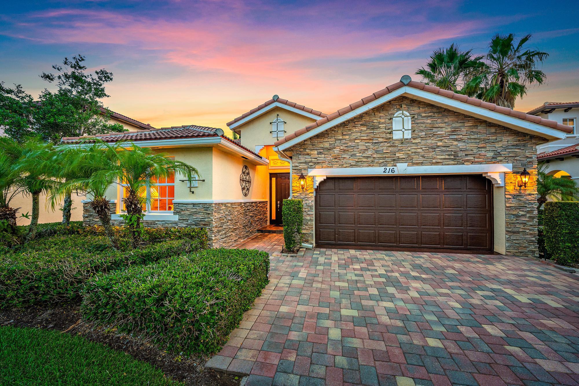 Located within the prestigious gated community of Rialto, this beautifully maintained one-story Cambridge model combines elegant design with the ease of luxury Florida living. Offering more than 2,300 square feet of thoughtfully designed space, the residence features three spacious bedrooms, two-and-a-half bathrooms, and a generous two-car garage. Enjoy picturesque lake views that create a tranquil setting for both everyday living and entertaining.  Inside, the home showcases tile flooring throughout the main living areas and laminate flooring in the guest bedrooms, blending durability with warmth and comfort. Crown molding adds an elevated touch throughout the interior, while the open-concept floor plan is enhanced by a charming half wall connecting the family and living spaces, creating definition without sacrificing flow. The spacious kitchen features stainless steel appliances that includes a new microwave, granite counter tops, warm wood cabinetry, and a spacious kitchen island for casual dining. It opens seamlessly into the main living areas, ideal for gatherings and casual living alike. The expansive primary suite offers a relaxing retreat with dual walk-in closets, and a spa-inspired bathroom complete with double vanities, walk in shower, and a soaking tub.   Additional highlights include impact windows for added protection and energy efficiency, along with a brand-new AC system installed in 2025 for peace of mind and year-round comfort. Step outside to enjoy your private lanai— the perfect place to unwind, entertain guests, or take in the serene waterfront scenery.   Rialto is a premier gated community known for its beautifully maintained surroundings, access to A-rated schools, and proximity to a scenic nature preserve. The HOA includes maintenance of both the front and back lawns, allowing for a truly low-maintenance lifestyle. Residents enjoy an impressive clubhouse complete with a state-of-the-art fitness center, a children's splash park, a resort-style pool and jacuzzi, multiple playgrounds, basketball courts, tennis courts, and miles of walking and jogging trails. An active social calendar offers events and activities for all ages, fostering a vibrant and welcoming community atmosphere.   Just across the street, Jupiter Community Park provides additional recreational opportunities with a variety of sports programs for both children and adults. Ideally located in the heart of Jupiter, this home is only minutes from pristine beaches, exceptional dining, and upscale shopping. With convenient access to I-95 and the Florida Turnpike, commuting is effortless, and Palm Beach International Airport is just a short drive away, making travel both simple and accessible.