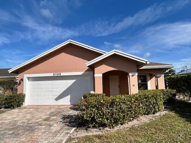 This amazing 3-bed, 2-bath home is located in a residential neighborhood just a few minutes' drive to Port Salerno waterfront & marina, perfect for coastal living.  Step inside to a bright, open, clean, and spacious living area with volume ceilings—ideal for entertainment. The primary suite features a private bathroom, a walk-in closet, and direct access to the backyard. Tile and laminate flooring run throughout, paired with new appliances for added peace of mind. Oversized, fully fenced yard with a screened patio! CBS construction, architectural shingles, a double driveway, a 2-car garage, and an indoor laundry room. This home is truly move-in ready! Motivated seller. No HOA.