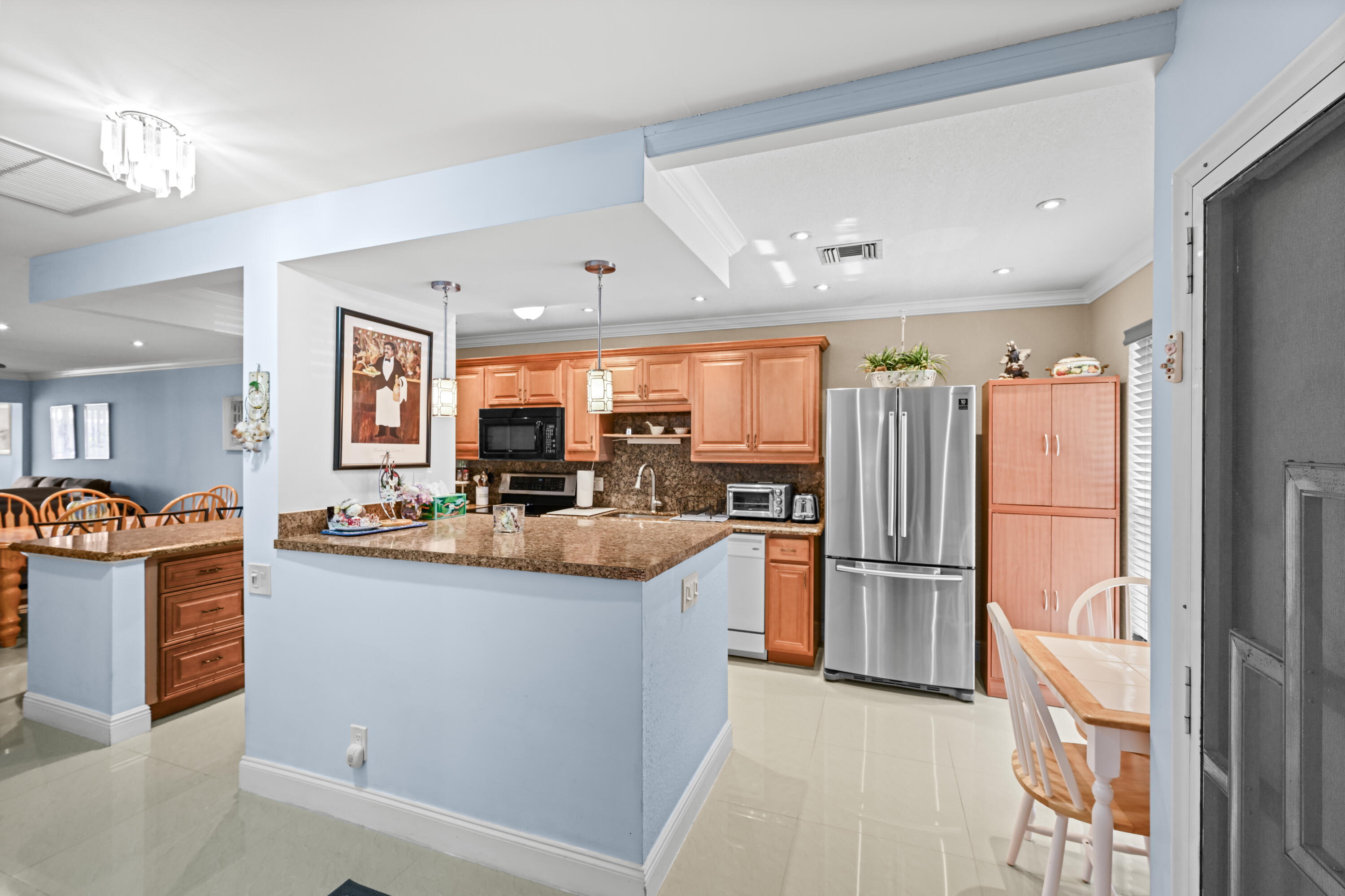 Bright, 2 Bedroom, 2 Bathroom sun-lit remodeled corner unit villa in Pines of Delray West—this one will not last! Offered furnished and featuring a 2-year-old forced-air system and condenser, updated electrical panel, and updated bathrooms, safety grab bars, new living room TV, and accordion storm shutters throughout. Enjoy an enclosed porch plus exterior patio, perfect for relaxing or entertaining. New living room TV included.