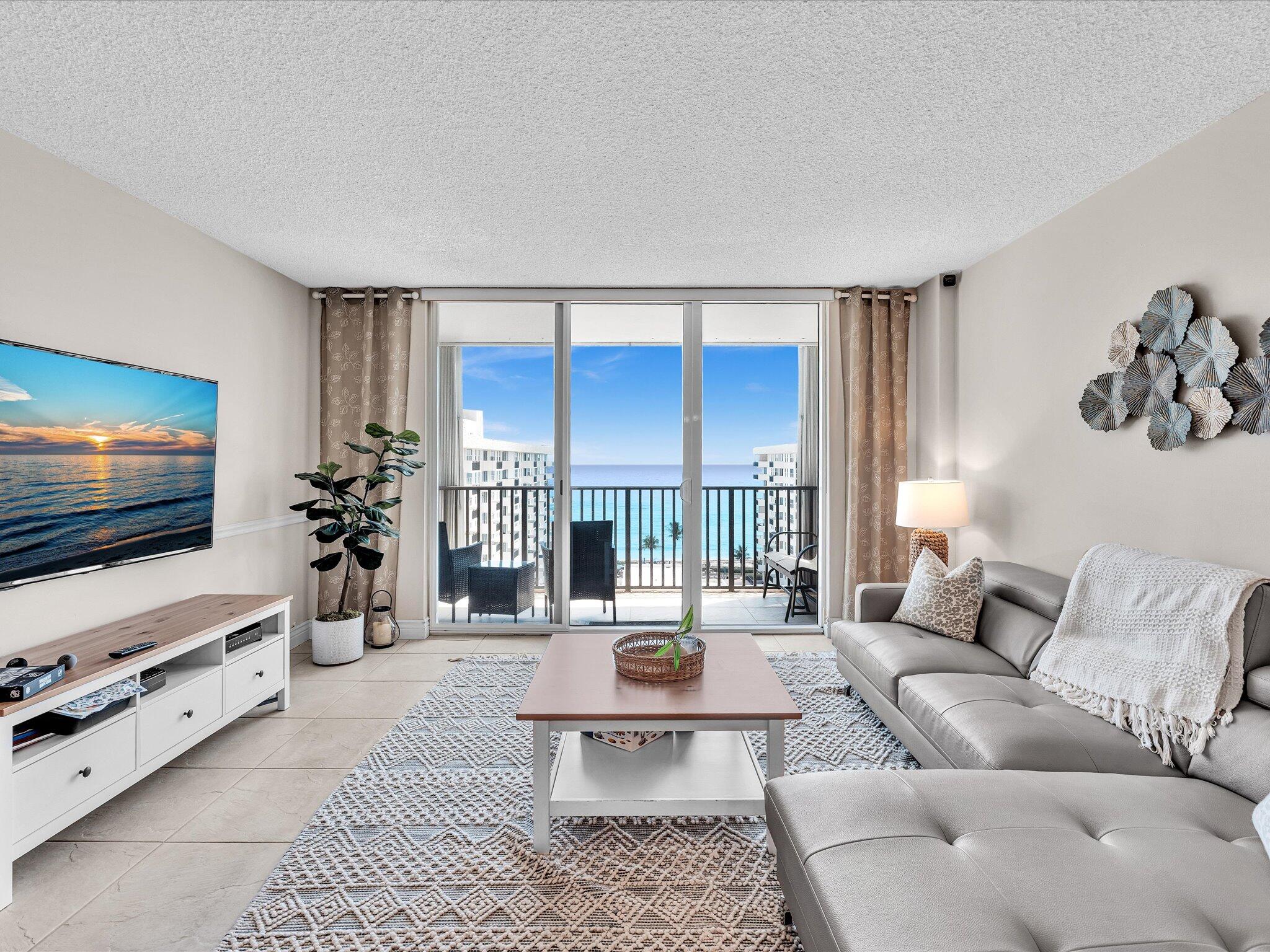 Step inside to this FULLY FURNISHED condo and you'll immediately be overtaken by the incredible and endless ocean views from every room.  The views are much better in person than in the photos.  Secondly, you'll notice how bright, clean, and welcoming this residence feels. The space has been thoughtfully updated with a modern traditional touch, featuring sleek ceramic tile flooring throughout and a neutral color palette that makes it easy to call HOME.  The kitchen is both stylish and functional, with updated cabinetry, quality countertops, and plenty of storage—perfect whether you're cooking a full meal or just putting together something quick before heading out. It opens nicely into the living and dining areas, creating a comfortable flow that's great for everyday living. The living area is spacious and filled with natural light, with large sliding glass doors that lead out to the balcony. It's the kind of space where you can relax during the day and unwind at night while taking in the views.  The bedrooms are fully equipped with quality furnishings and are generously sized with ample closet space, giving you both comfort and practicality. The bathrooms have also been refreshed with clean, modern finishes that keep everything feeling crisp and move-in ready.  Living at Opal Towers West means embracing resort-style amenities just steps from your door: a heated pool overlooking the Intracoastal, deeded private beach access directly across the street for sun-soaked days on pristine sands of the Atlantic Ocean, a fitness center, billiards room, clubroom, barbecue areas, and security for added peace of mind. The building offers that perfect blend of low-maintenance convenience and coastal charm.  This is a must see and the best deal on the Mile.