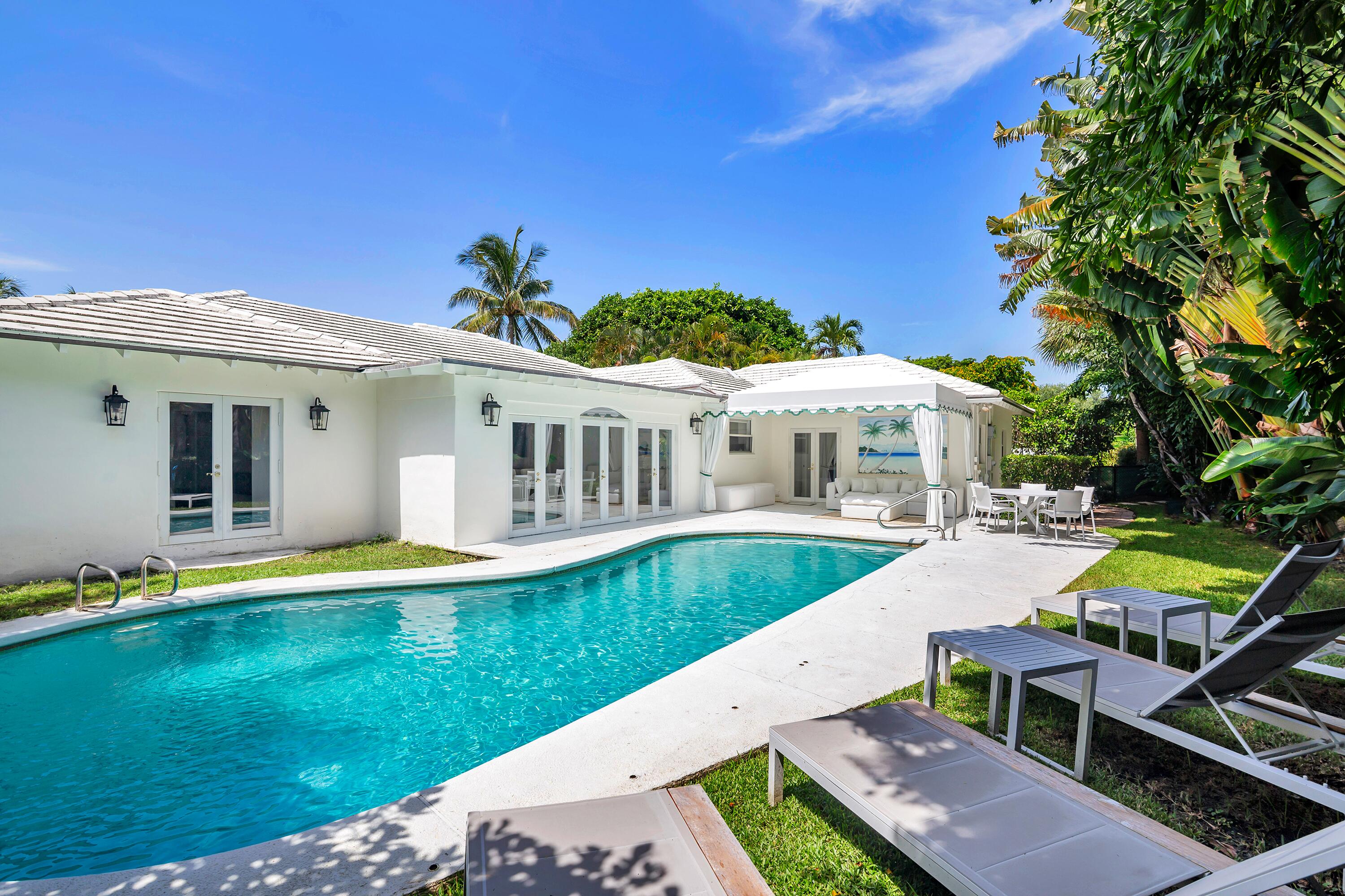 235 Ocean Terrace presents a rare opportunity on Palm Beach's coveted North End, ideally situated on one of the island's premier cabana streets with dedicated beach access and just moments from the Lake Trail. Set on a 10,018± square foot lot, the residence offers 3,336± total square feet with four bedrooms and four full bathrooms. A welcoming foyer leads to the living and dining rooms, while the kitchen overlooks the pool and patio. The primary suite features direct access to the pool, and each bedroom includes an en suite bath.  A covered loggia overlooks the pool and patio, providing an inviting setting for outdoor living and entertaining. Additional highlights include a one-car garage and laundry room. An exceptional opportunity to enjoy, renovate, or reimagine a residence in one of Palm Beach's most desirable North End locations.