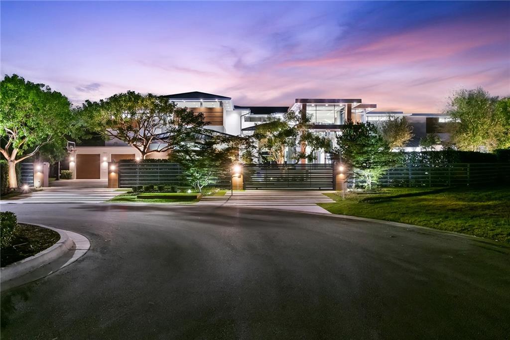 Truly a designers Masterpiece! Located on an exquisite lot in Hawks Landing, this modern 17,400 sq. ft. gated lakefront property transcends luxury living. Floating aluminum walls, porcelain floors paired with 2 floating steel staircases, recessed Glottman lighting, and myriad Boffi designs enhance this 35-ft. ceiling, 7-bedroom, 11 bath home. The NY loft-style master suite with sliding oak Dayoris doors overlooks the lake, offering sunset views. Nano doors in the chef’s kitchen open to an outdoor living area with a summer kitchen, flanked by an 80x40 ft. heated pool, waterfall, and Jacuzzi perfect for gatherings. A private gym overlooking the water, a glass enclosed wine room, an 8-seat home theatre and a Zen style sanctuary guesthouse. This Estate is nothing short of an opulent lifestyle. The aesthetic involves solid rich hardwoods and custom quarried Italian Limestone walls all embraced by the magnificent commercial grade hurricane glass.In addition this residence offers a formal living room, formal dining room, an additional living, dining and family room upstairs with large outdoor patio, complimented by a Zen Style sanctuary guest house, 5 car garage and parking for 20+ cars within the gate.Exquisite master suite with Poliform closets complete the picture with glass doors and an island; all have leather counter tops. A Stunning designed Boffi master bathroom creating the ultimate private and romantic suite.The Bulthaup kitchen offers double Sub Zero Refrigerators, Freezers and Wolf Gas Cooktops, full butlers pantry and Nano doors in this ‘chef's’ kitchen open on to an outdoor living area perfect for large gatherings and includes a well equipped summer kitchen with Twin Eagles Grill, 4 refrigerators, a wine refrigerator, heating drawer, sink, griddle and double burners. An 80 x 40 ft. style heated pool, reminiscent of those found at opulent resorts with waterfalls, sun bathing area and jacuzzi, overlooked by the entire home.Crestron Complete Smart Home comes with Cameras, Audio, Security and Surround Sound. As you would expect it also includes a full house Generator, Commercial Elevator and Commercial Fire Alarm. With the lush landscape and hardscape designed and installed by World renowned, KWD Company, the courtyard and driveway is immaculately mud set paved.The encore to this luxurious Hawks Landing lifestyle comes through the $15 million Hawks Landing Club. Highlighted by a 15,000 sq.ft. Mediterranean-style clubhouse, the Hawks Landing Club is an extraordinary oasis. Offering seven immaculate Har-tru lighted tennis courts and luxury hotel style Pool.