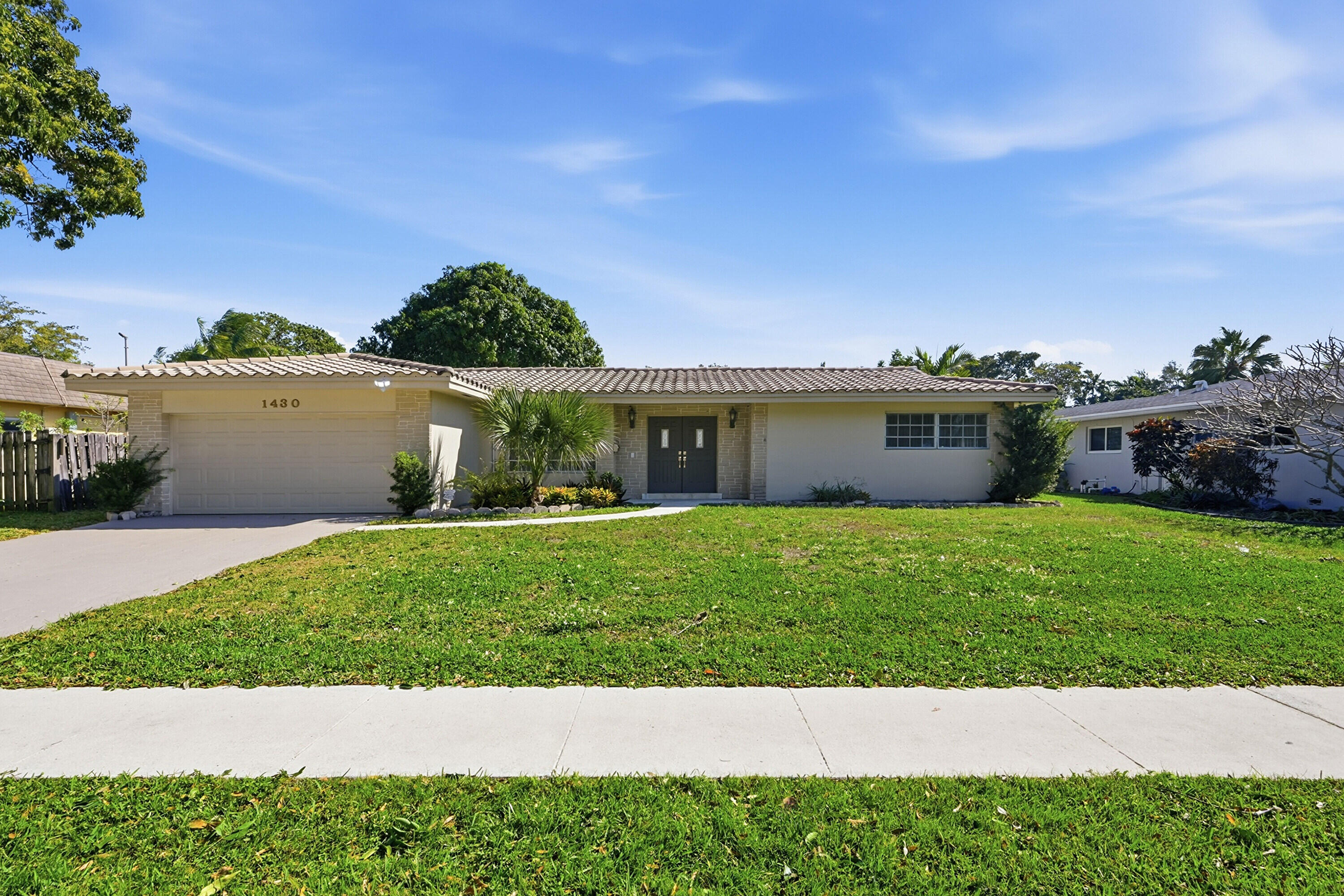 Welcome to this exceptional 4-bedroom, 2-bathroom home, located in Plantation, FL. This single-story residence spans 1,964 square feet of finished living space and offers the unique advantage of waterfront property ownership.  Upscale remodeling,  Duistinctive top of line appliances, tile floor throughout.  Perfect split floor plan for privacy and quiet.  Sparkling Diamond Brite pool, extra long for lap swimming, huge covered patio, becomes irresistable outdoor living area.  Big 2 car garage with room for delux new washer and dryer on elevated stands, and new hot water heater.  Fenceed back yard, small banana plantation, and fabulous mango tree.  Owner Financing Option Considered.  Additional advantages, Trust Owned, Ask for details. Property is priced below market value. As Is. Largest Model in Mirror Lake.  Remodeled.  Possible Owner Financing with Large Downpayment and Strong Qualifications.  As for money saving details of purching in Trust.