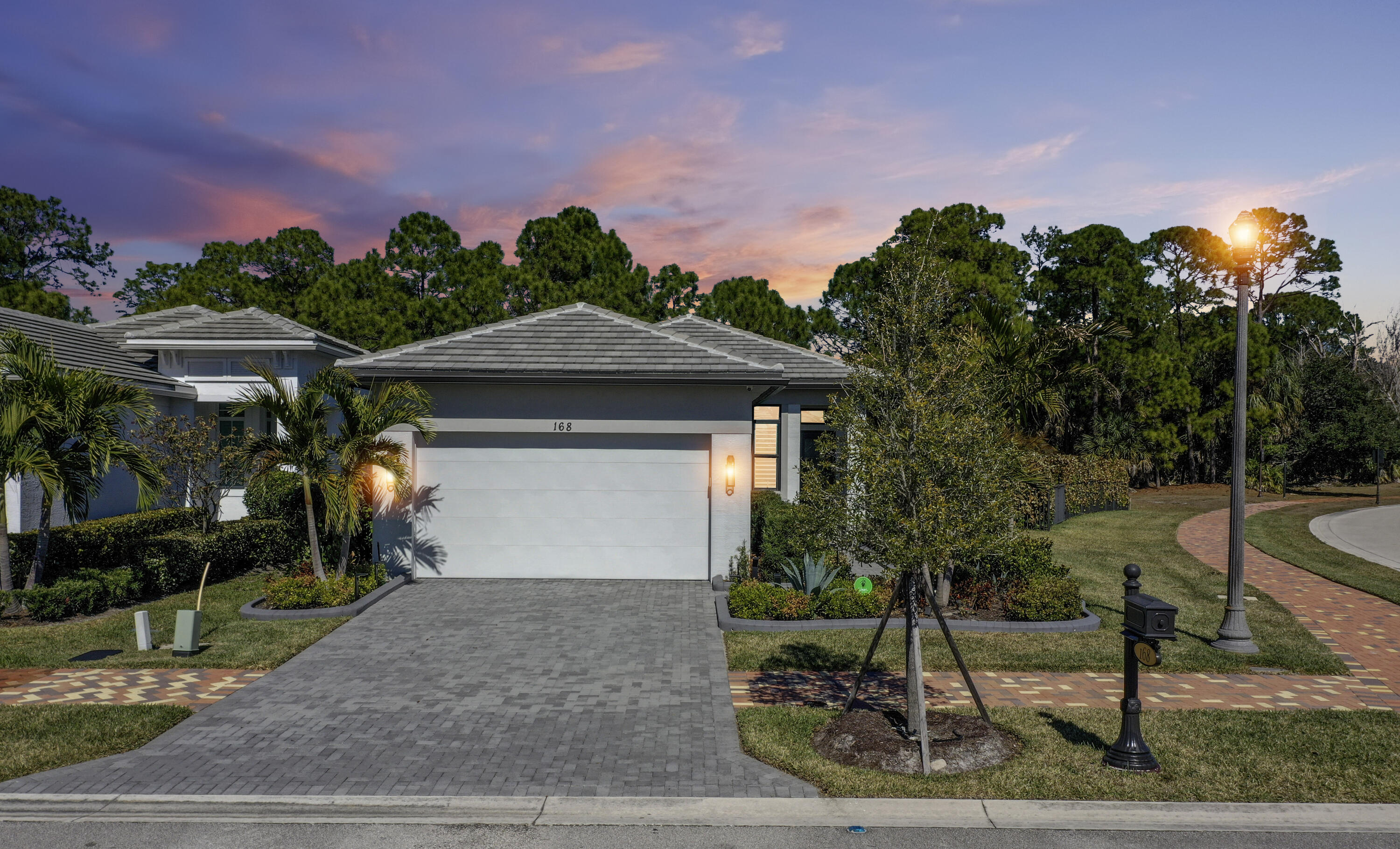 Private Corner Lot | Designer Upgrades | Fully Integrated Smart Home  Not all homes in Rivella are created equal. This upgraded, model-like residence is set on a rare oversized corner lot with only one neighboring home, offering a level of privacy and preserve-facing tranquility that interior lots simply cannot match.  Inside, the home reflects true pride of ownership and thoughtful investment, featuring premium Mohawk luxury vinyl flooring, Sherwin-Williams Agreeable Gray, and custom plantation shutters throughout—creating a cohesive, designer-level finish. Unlike standard builds, this home is fully equipped with integrated smart technology, including:  Lutron Caseta lighting system. Motorized solar shades and custom blackout drapery. App and voice control for seamless daily living.  The lifestyle continues outdoors with a 500+ sq ft covered and screened lanai, enhanced by a whole-home Sonos sound system extending inside and out—ideal for both entertaining and quiet evenings in complete privacy.  Additional premium features include:  *75" living room TV + 65" primary suite TV  *Custom-designed closets in both bedrooms *Whole-home surge protection (including AC) *UV air purification system in HVAC *Smart garage system (MyQ) with camera + remote access  The outdoor space is already prepared with rough-ins for a summer kitchen, hot tub, and additional electrical, plus ample room for a custom pool—saving future owners time, cost, and effort. A rare combination of privacy, technology, and turnkey upgrades—this is more than a home, it's an elevated living experience!