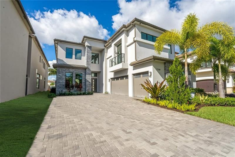 Located in Boca Bridges, a coveted GL community in Boca Raton, this new construction property is a 5,771 SQ FT contemporary Monticello model with 5 bedrooms and 6 bathrooms. Pass through the two-story foyer into the massive open-concept great room, gourmet kitchen and family dining alcove which opens to the covered back patio and pool (currently being built). Upstairs, the master suite displays a coffered ceiling, 2 walk-in closets, standalone tub, walk-in shower and his/hers sinks. Additional features include a formal dining room, wet bar, game room and 3-car garage. Boca Bridges offers a 27,000 SQ FT clubhouse complex with a restaurant, full-service pool, bar, game room, fitness center, tennis courts and more. Just steps away from the water, act now on this all-in-one luxury residence.