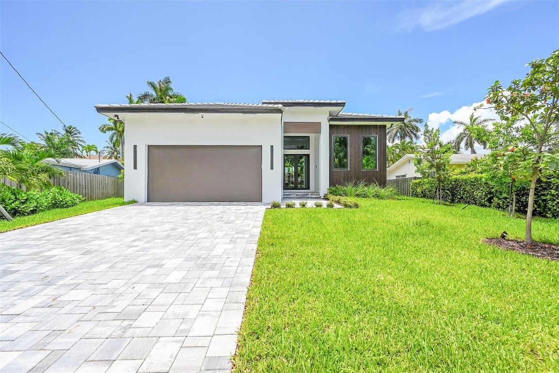 Newly-constructed Wilton Manors luxury waterfront residence located on Middle River with a new 85-ft seawall and ocean access, 3 spacious bedrooms and 3 designer bathrooms, blending timeless elegance with expert craftsmanship. This home comes equipped with a chef’s kitchen design with high end appliances, quartz countertops, and an outdoor kitchen. The expansive living area features premium finishes and floor-to-ceiling windows, creating a seamless indoor-outdoor feel. Centrally located near Wilton Manors Drive, this home is walking distance from all things Wilton Manors and a short drive to Downtown Fort Lauderdale/Las Olas, the beach, great shopping and restaurants, and Fort Lauderdale Airport. POOL OPTION: Photos of pool are renderings.