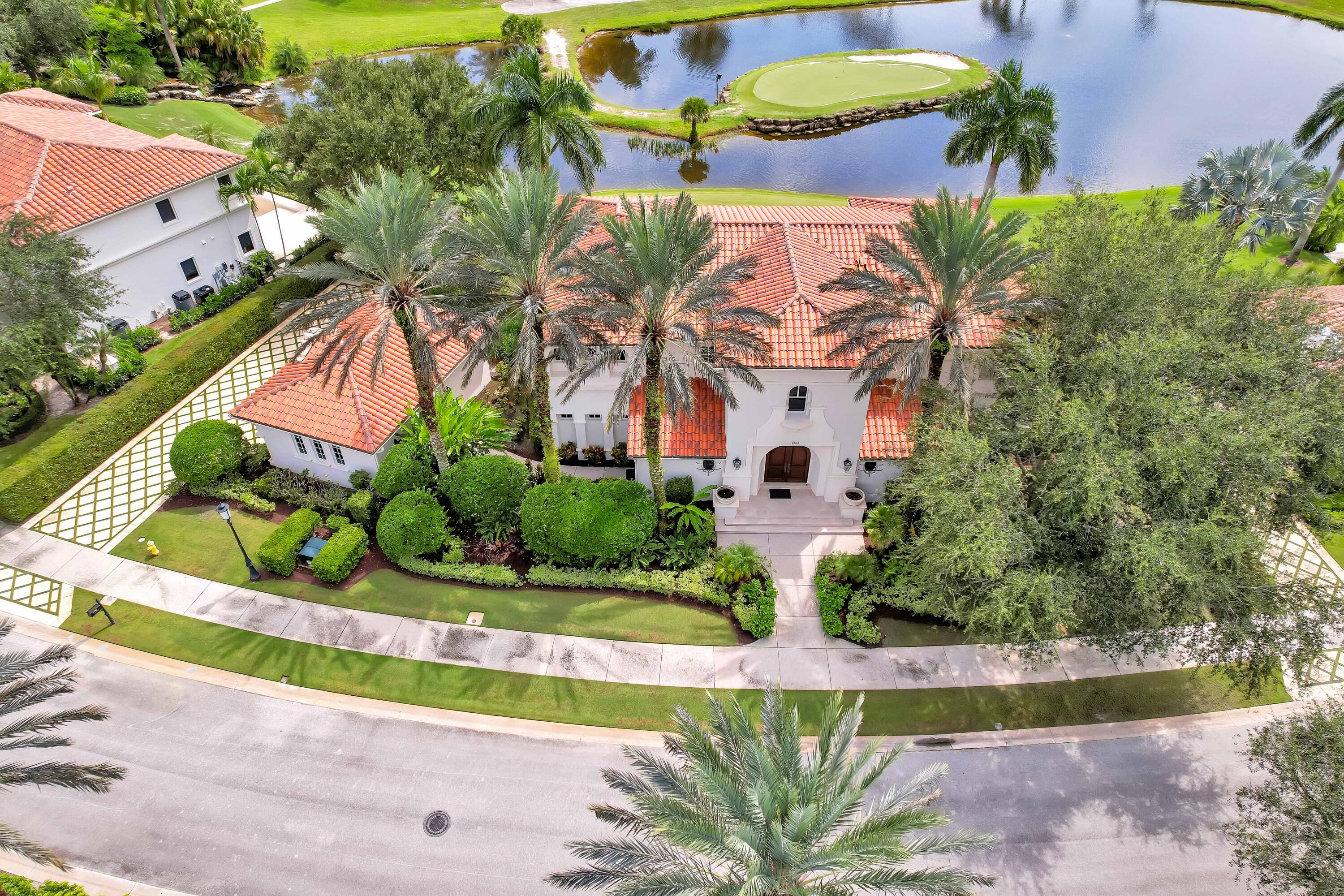 HOME PURCHASE INCLUDES CLUB AND GOLF MEDALLION MEMBERSHIP. This elegant stately home is over 5,200 square feet under air and centers around a two-story great room with a balcony on the second floor with panoramic views of Old Palm. The floor plan includes four spacious primary bedroom suites overlooking the Lake, golf course, 19th hole, and the newly renovated and expanded Old Palm Club House. This is a rare opportunity to enjoy all the world-class amenities that Old Palm has to offer without purchasing an Equity membership. Through the Medallion membership program, offered only to the owners of the Golf Cottages, a minimum of two memberships and up to four memberships are available simply by paying annual dues. Club membership provides the opportunity to play on this pristine signature Raymond Floyd designed course which includes a highly thought of caddy program. Old Palm also offers a separately located three hole 33 acre practice studio complete with Trackman V-1 swing analysis. The Clubhouse, in addition to its recent renovations, features casual and fine dining and both men's and women's lounges / locker rooms. In addition, there is a newly built Life Style Center with a two Story fitness center that includes a men's and women's spa, infrared sauna, cold plunge, and beautiful 4 lane lap pool.