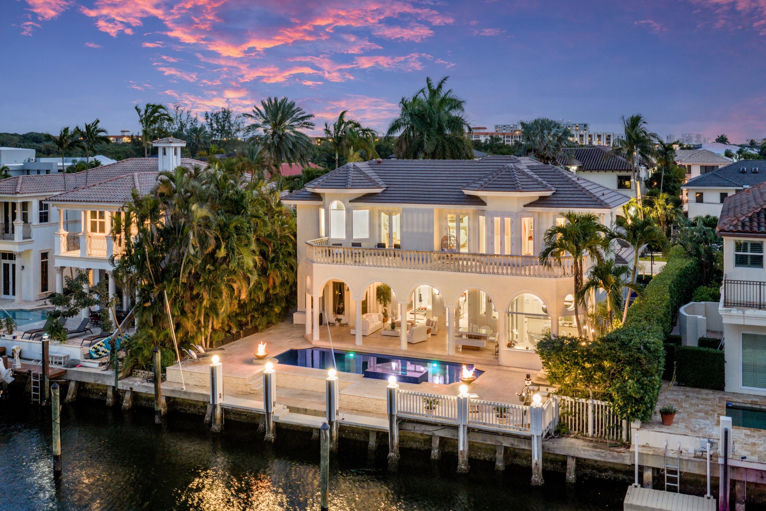 Set along 80 feet of deepwater frontage in Boca Raton's desirable Lake Rogers community, this five-bedroom waterfront residence offers a private dock with easy ocean access, desirable for boaters.   Bright, sun-filled interiors unfold through numerous impact windows and doors, creating an airy two-story layout designed for comfortable living and relaxed entertaining.  The kitchen features granite countertops, stainless-steel appliances, and an eat-in dining area overlooking the water, opening seamlessly to the family room where tranquil views of the heated pool, spa, and canal become part of everyday living. The thoughtfully designed floor plan offers five bedrooms, each with walk-in closets, including the advantage of two primary suites located on both the first and second floors for flexible living arrangements.  Outdoors, the waterfront setting comes to life with a heated pool and spillover spa surrounded by an expansive patio, complete with a wet bar and barbecue area for effortless entertaining beside the water.  Ideally positioned near the beach, this retreat offers the best of Boca Raton's coastal lifestyle with boating, waterfront living, and scenic sunrise and sunset walks just moments away.  The information published and provided including but not limited to prices, measurements, square footages, lot sizes, features, finishes, and calculations are subject to errors, omissions or changes without notice. All such information should be independently verified. All parties should perform their own due diligence to verify all information.