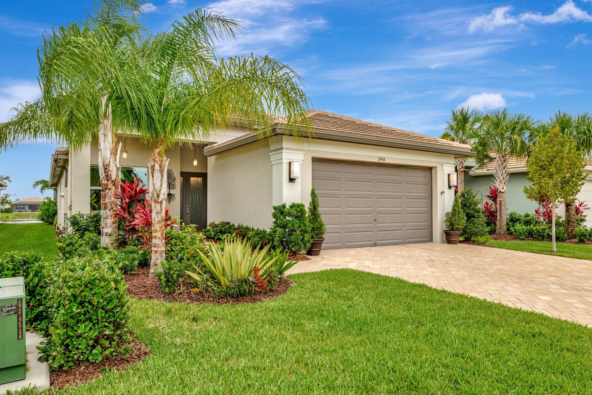 FOR SALE - Beautifully Upgraded Sierra Model in GL Homes' Premier 55+ Valencia Grove at Riverland, in Port Saint Lucie, FL Why wait months for new construction when you can move right into this beautifully upgraded, meticulously maintained Sierra model? Skip the uncertainty of build timelines, additional upgrade costs, and start enjoying the Riverland lifestyle now in this exceptional move-in-ready home. Offering 2,064 square feet under air with 3 bedrooms and 2 bathrooms, this home combines timeless design with thoughtful, high-end upgrades throughout. Enjoy breathtaking west-facing long lake views and spectacular sunsets from the extended screened lanai, complete with a convenient roll-down shade screen. The exterior also features widened driveway and walkway pavers, a tankless water  heater, and an elegant glass entry door with sidelight for outstanding curb appeal. Inside, luxury light gray vinyl plank flooring flows throughout the home, complemented by crown molding, custom closet systems in every bedroom, electric Zebra blinds, and three included TVs. A convenient floor outlet in the living room makes the perfect setup for powered reclining furniture. The gourmet kitchen is designed to impress with Willow soft-close cabinetry featuring pull-out shelves, glass display inserts, under- and over-cabinet lighting, Silestone Miami White countertops, upgraded Kohler fixtures, and a premium suite of GE Profile appliances, including a counter-depth French door refrigerator, slide-in gas range, chimney-style hood, and dishwasher. The spacious primary suite offers a true spa-like retreat with plank tile flooring, a frameless glass shower with floor-to-ceiling tile, heated towel racks, a smart-height Kohler toilet, pocket doors to the closets and water closet, soft-close cabinetry, and upgraded Moen fixtures. The guest bathroom showcases equally impressive finishes with designer tiles, Kohler upgrades, and a contemporary rectangular sink. Additional highlights include a stylish barn door that provides privacy for the den or home office, and a well-appointed laundry room featuring white soft-close cabinetry above the washer and dryer for additional storage.   If you are looking for a turnkey, move-in-ready home, the furniture is negotiable separately. The home is tenant-occupied until August 31, 2026. Residents of Valencia Grove enjoy an unmatched resort lifestyle with spectacular clubhouses, resort-style pools, state-of-the-art fitness centers, arts and culture studios, miles of walking and biking trails, and more than 50 pickleball and tennis courts. Beyond the gates, you'll appreciate being just minutes from Cleveland Clinic Tradition Hospital, shopping at Tradition Town Center, an abundance of fine and casual dining, championship golf, New York Mets spring training at Clover Park, beautiful Treasure Coast beaches, and convenient access to I-95 and Florida's Turnpike. This exceptional Sierra offers the luxury, upgrades, and lifestyle today's buyers are searching for—without the wait. Schedule your private showing today!