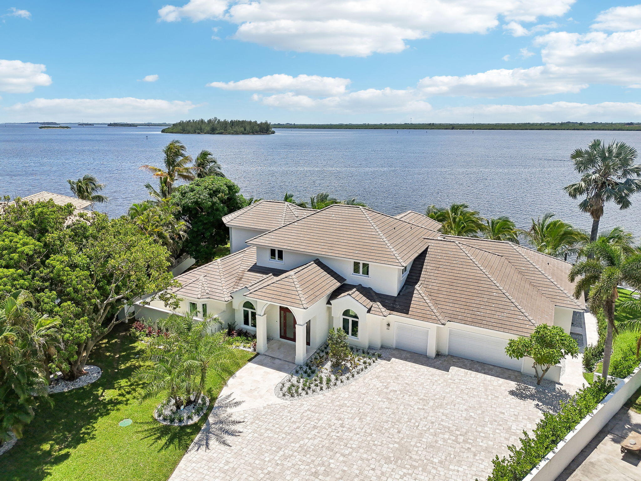 Welcome to 526 Point Lane in beautiful Vero Beach! This incredible waterfront home, fully renovated in 2025, offers 212 feet of stunning Indian River frontage. With 5,885 sq. ft. of luxurious living space, it features 5 bedrooms, each with its own ensuite bathroom, plus two additional half baths. The home is designed for entertaining, boasting a chef's kitchen with top-of-the-line Viking and Sub-Zero appliances and a custom bar. High ceilings and a dramatic 20-foot glass fireplace wall create a grand ambiance. Enjoy the lushly landscaped outdoor oasis with a brand-new heated pool and spa. Boating enthusiasts will love the new seawall and private dock. Other highlights include a primary suite on the first floor, a large 3-car garage and nearby beach access. Your slice of paradise awaits!