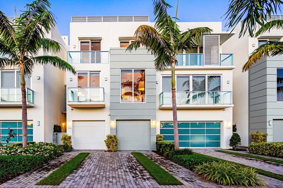 Located just three blocks from the Atlantic Ocean and Atlantic Ave, the sensational waterfront townhouse at 126 MacFarlane Dr features an elegant sophistication that is complimented by a contemporary design. Nestled along the Intracoastal Waterway, Seagate Yacht Club is an enclave of 10 units with stunning curb appeal and superb East Delray location. The four bedroom townhouse has the perfect floorplan for maximizing privacy and amazing views of the marina and Intracoastal Waterway. Features include gourmet kitchen; living room with fireplace and balcony; luxurious master wing; elevator; generator and impact glass. Enjoy the private pool and spacious rooftop terrace with summer kitchen and fire pit for enjoying the sunrise, watching the boating activity and relaxing amidst sunset views. Designed and built in 2016 to the highest of standards, this townhouse is in immaculate condition with spacious living areas and abundant privacy. Each of the three stories uniquely maximizes the natural light to create a tranquil setting amidst the water views. The interior offers the perfect balance of contemporary design and elegant décor to create a gorgeous East Delray Beach residence for enjoying South Florida luxury living. 

Features Include:
" Luxurious townhouse; three stories plus rooftop terrace
" Four bedroom / four full and one-half bath
" 4,486 square feet under air / 6,943 total square feet
" Fabulous beach area location just blocks from the beach and Atlantic Avenue
" Stunning Seagate Yacht Club complex with manicured landscape and phenomenal curb appeal
" Decorative driveway and pathway to front gate and entry
" Volume ceilings; high-end finishes and décor including custom wall covering; wood floors and water views throughout
" Foyer with under-stairway sitting area and first glimpse of modern yet elegant décor
" First floor bonus room overlooking private pool, marina and Intracoastal waterway; sliders to covered loggia and pool; room can serve as family room, office or recreation room
" First floor bedroom/den with full bath across hallway
" Laundry room with full-size washer dryer, sink and ample cabinets and countertops
" Stairway and elevator access to all levels
" Second floor landing offers sitting area and powder room
" Gourmet kitchen with large island and snack bar seating; top-of-the-line appliances; lots of cabinets and storage; and double door wine cooler
" Dining room off kitchen has solid wall of glass windows overlooking the Intracoastal Waterway
" Living room has linear gas fireplace and sliders to balcony
" Second floor east-facing guest bedroom has walk-in closet, full bath with large glass shower and private balcony 
" Third floor landing is open to the second level and roof-top level allowing natural light to cascade through the interior
" Spacious and private master bedroom with sitting area overlooking the Intracoastal Waterway; two balconies; dual walk-in closets; and luxurious master bath with dual vanities, soaking tub and glass shower and linen closet 
" Third floor guest bedroom with sliders to large east-facing balcony, walk-in closet and full bath
" Hallway storage closet is plumbed for second washer and dryer
" Expansive rooftop terrace for enjoying sunrise and sunset views as well as boating activity; ample space for outdoor living and dining areas; firepit; summer kitchen with grill, sink and frig; equipment area with room for storage
" Private pool with covered loggia; privacy wall with access gate to marina and Intracoastal Waterway; 
" Smart house technology; security system; privacy wall in front and back with gate
" Two-car garage; storage throughout property
" Full house generator; impact windows and doors; three-zone air-conditioners