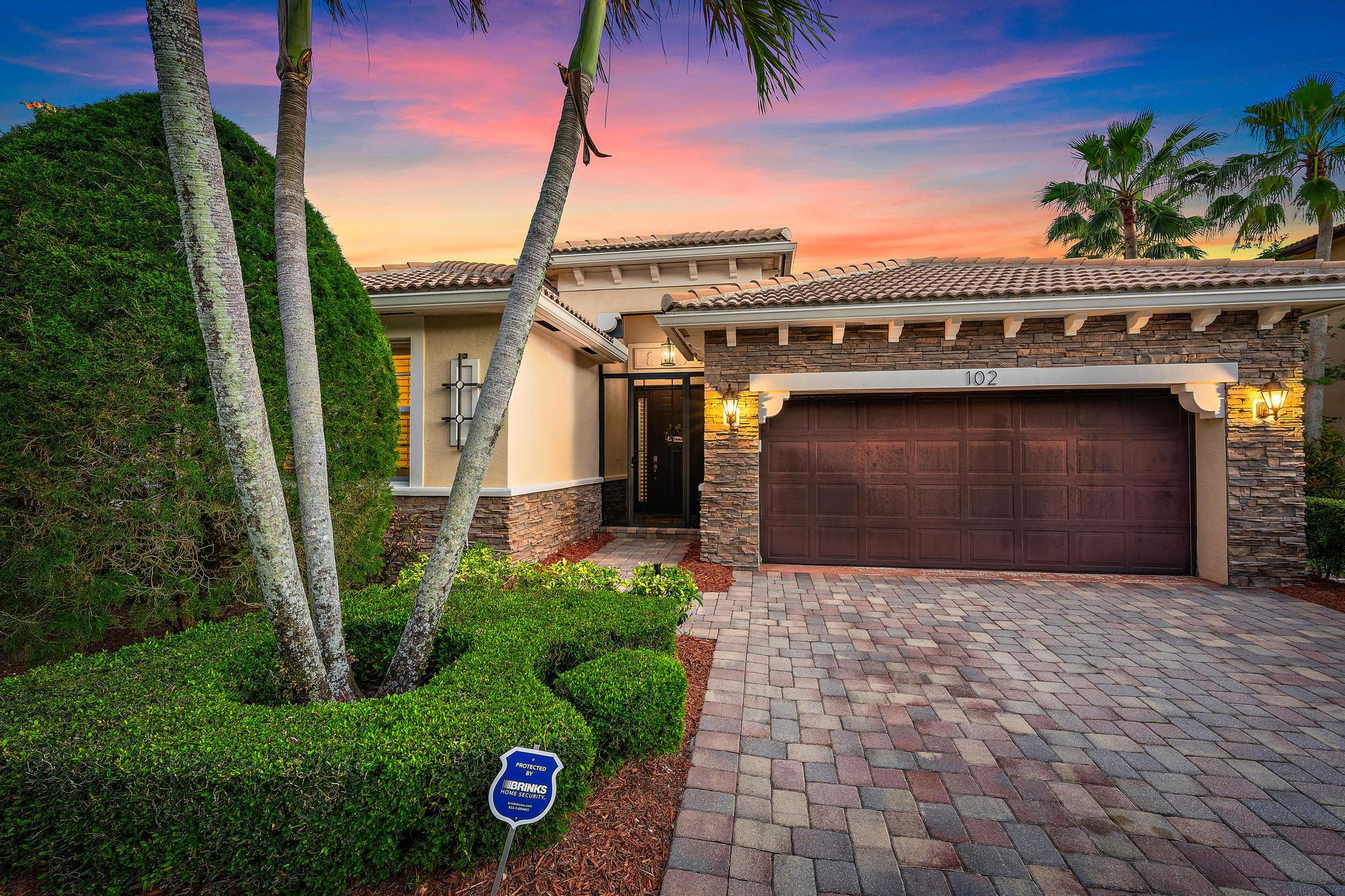 Nestled within the prestigious gated community of Rialto, this elegant one-story Cambridge model lakefront residence offers the perfect blend of luxury, comfort, and refined Florida living. With over 2,300 square feet of thoughtfully designed living space, featuring three bedrooms, two and a half baths, and a spacious two-car garage. Situated on a prime corner lot with a serene preserve across the street, the property boasts a private backyard with an extended deck and picturesque lake views, creating an ideal setting for relaxation or entertaining. The interior space offers warm wood flooring, new AC, and a generous primary suite with decorative accent wall and dual walk in closets. The primary bath welcomes you with a soaking tub and dual vanities. Impact windows and doors provide energy efficiency and peace of mind.  Rialto is a premier gated community known for its beautifully maintained surroundings, access to A-rated schools, and proximity to a scenic nature preserve. The HOA includes maintenance of both the front and back lawns, allowing for a truly low-maintenance lifestyle. Residents enjoy an impressive clubhouse complete with a state-of-the-art fitness center, a children's splash park, a resort-style pool and jacuzzi, multiple playgrounds, basketball courts, tennis courts, and miles of walking and jogging trails. An active social calendar offers events and activities for all ages, fostering a vibrant and welcoming community atmosphere. Just across the street, Jupiter Community Park provides additional recreational opportunities with a variety of sports programs for both children and adults.  Ideally located in the heart of Jupiter, this home is only minutes from pristine beaches, exceptional dining, and upscale shopping. With convenient access to I-95 and the Florida Turnpike, commuting is effortless, and Palm Beach International Airport is just a short drive away, making travel both simple and accessible.