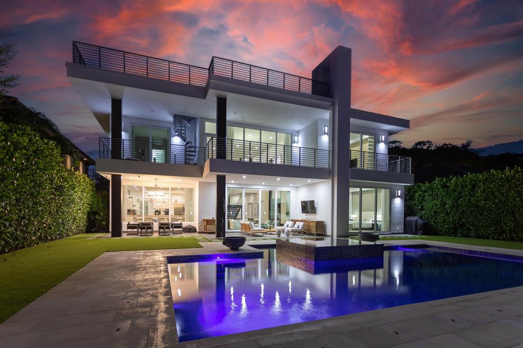 Magnificent DIRECT INTRACOASTAL modern residence that perfectly suits today's South Florida lifestyle. High end custom finishes and built-ins throughout with beautifully designed interiors. Large open floor plan with Chefs kitchen, Office, Media room, home gym, Upstairs and downstairs master, his and hers water-closet, roof top terrace and a full house generator plus much more. This ultra  relaxing waterfront oasis is the perfect home for entertaining with indoor/outdoor living. This home is a MUST SEE! Featured in Modern Luxury Magazine 2016.