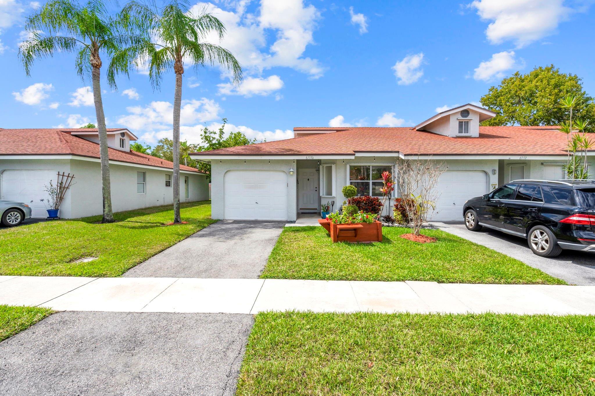 Welcome to your new home in sought-after Coral Palms of Tamarac! This rarely available 2-bedroom, 2-bathroom corner villa with a 1-car garage is a gem waiting to be discovered. It has an excellent open concept design that effortlessly blends functionality with style. Vaulted ceilings creating an airy & inviting atmosphere flooded with beautiful natural light. Large Master suite boasts a spacious walk-in closet & 2nd closet, offering ample storage. Step outside to the screened patio to unwind & enjoy the serene surroundings in privacy.  Coral Palms has host of amenities, including landscaping, community pool for those sunny Florida days, a well-equipped gym to stay fit, and a clubhouse for social gatherings and events. Schedule a showing today & make this Coral Palms villa your new home!