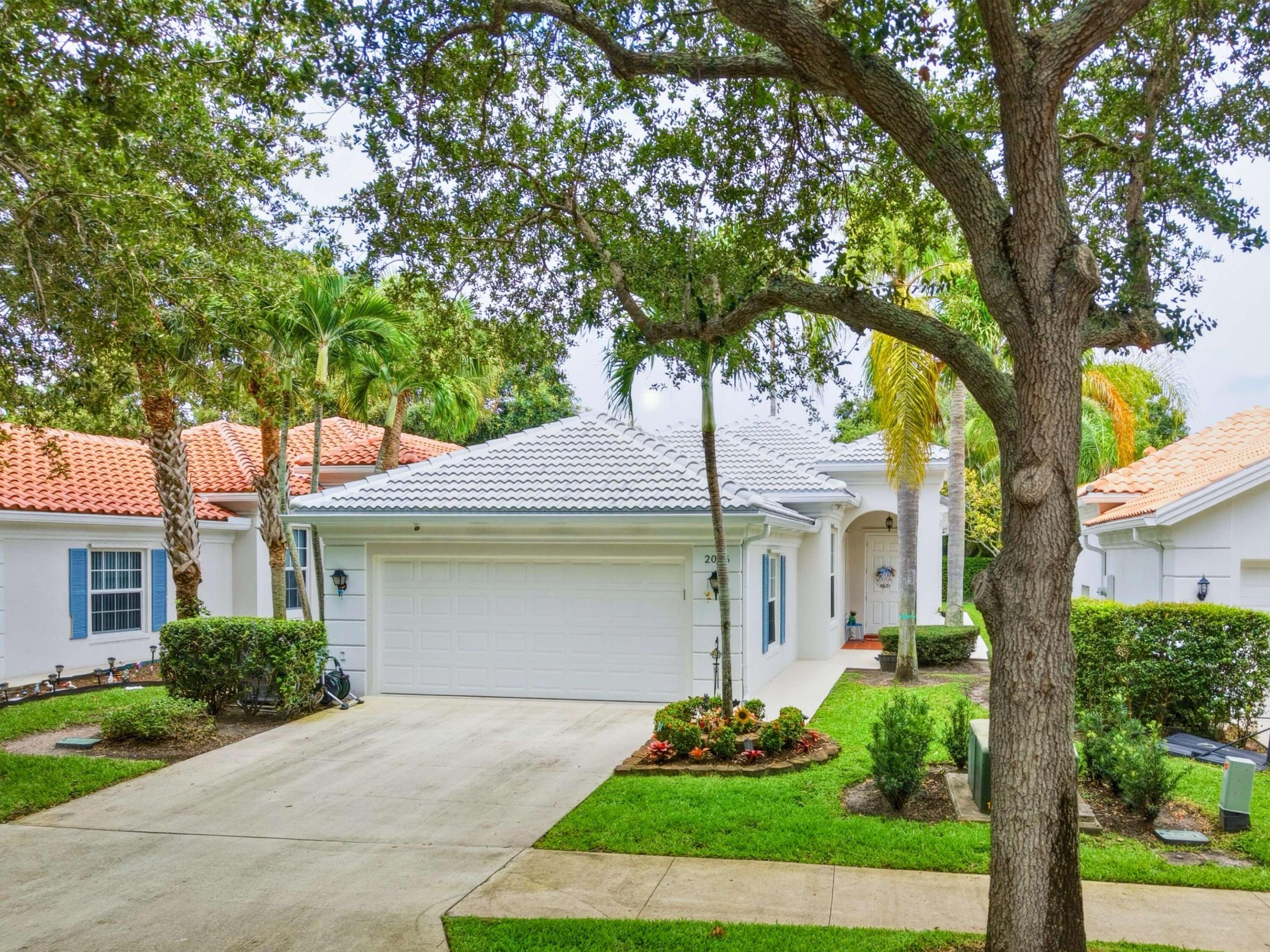Welcome to a beautifully maintained 3-bedroom, 2-bath residence offering 1,711 square feet of comfortable single-story living in one of Delray Beach's most desirable gated communities. Nestled among picturesque oak tree-lined streets, this home combines timeless charm with valuable modern updates.  Enjoy peace of mind with a BRAND NEW ROOF (2026) and IMPACT WINDOWS, providing enhanced storm protection, energy efficiency, and potential insurance savings. Inside, the bright and open floor plan is complemented by engineered hardwood flooring throughout, creating a warm and inviting atmosphere. The spacious living and dining areas flow seamlessly to an extended lanai, perfect for relaxing or entertaining while enjoying the privacy of the tranquil backyard setting. Additional features include an updated air conditioning system, hot water heater, appliances, washer and dryer, impact-rated garage door, central vacuum system, built-in garage storage, and custom living room wall unit. Built by renowned DiVosta Homes, this residence reflects quality construction and pride of ownership throughout.  Ideally located just minutes from shopping, dining, medical facilities, airports, and the vibrant restaurants, boutiques, and beaches of downtown Delray Beach. A rare opportunity to own a move-in ready home with major capital improvements already completed.