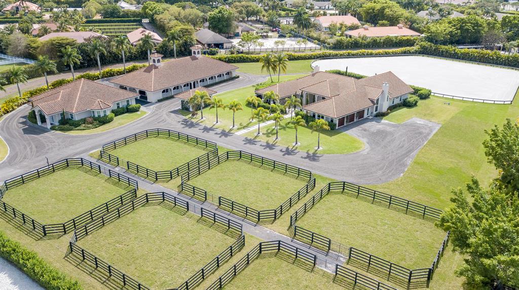 Impeccable horse farm on 3.6 acres of land in the Saddle Trail Park neighborhood, located on the south side of Greenbriar Blvd. and just a short hack to the WEF showgrounds. The main house boasts four bedrooms, three-full and one-half baths, vaulted ceilings, and tons of natural light flowing through the impact glass windows. The kitchen is a spacious dream, with an oversized island. New hardwood floors flow throughout much of the main living spaces and gorgeous brick fireplaces serve as focal points in the living room, family room, and master bedroom. The backyard to the main house is fully fenced and enjoys a covered patio and relaxing pool. Newly enlarged arena and drainage system make this property perfect!! There is a 14 stall barn with a 2 bedroom 2 bathroom guest house or grooms quarters, riding arena and ample parking.