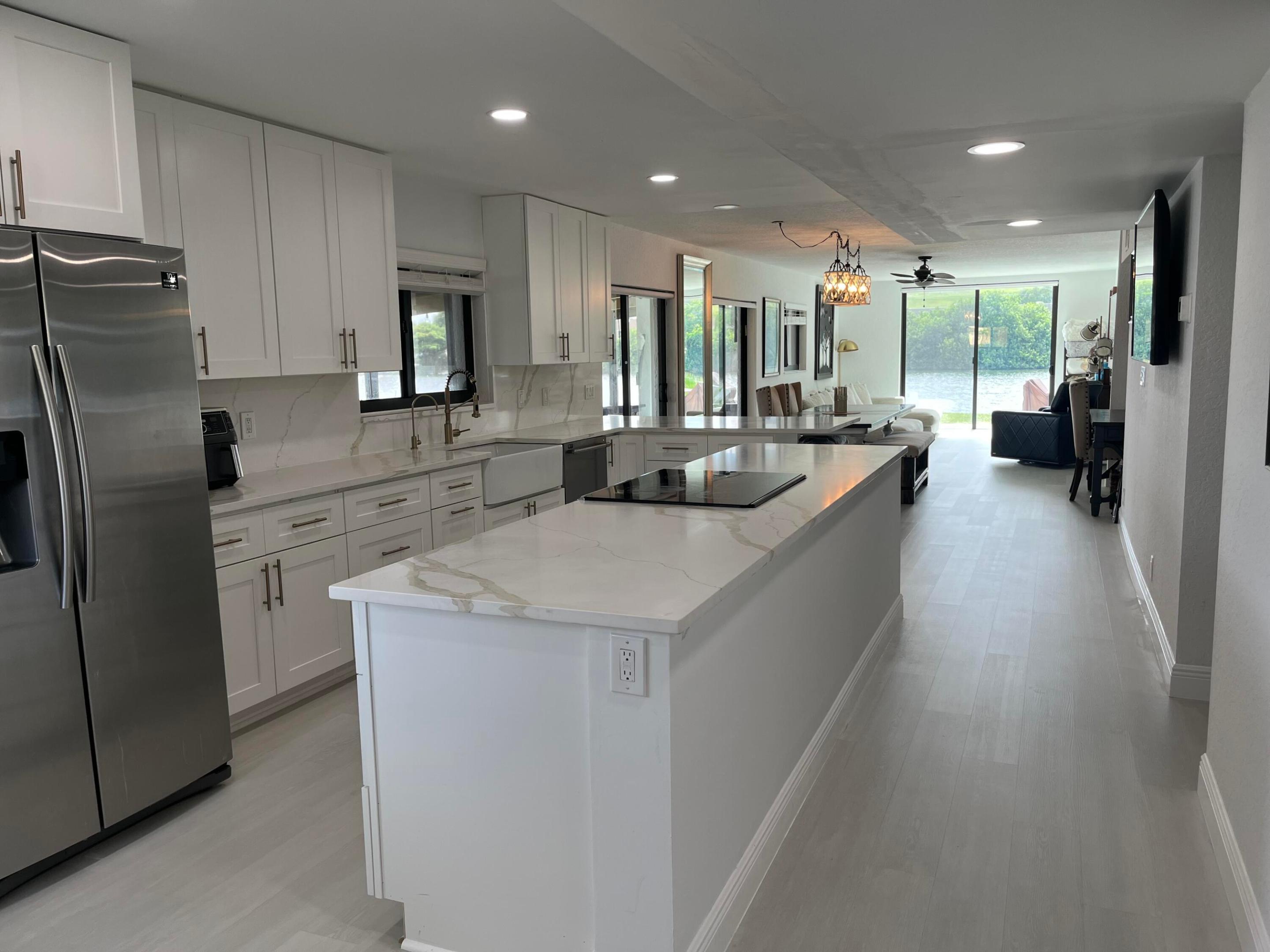 Rare opportunity to own one of the most desirable waterfront residences on private Crystal Lake! Completely remodeled 2BR/2BA end-unit condo featuring the largest screened patio in the community—more than twice the size of most units—new hurricane impact windows and doors, and the only unit with a full-size washer and dryer inside. Sale includes a boat, private boat slip, and boat lift! Enjoy boating, water skiing, wakeboarding, tubing, fishing, and more on this private lake with no public access. Private boat ramp, dock, and lift are just steps from your patio. Community pool overlooks the lake. Conveniently located near beaches, shopping, dining, major highways, and Fort Lauderdale Airport. A truly one-of-a-kind waterfront lifestyle!