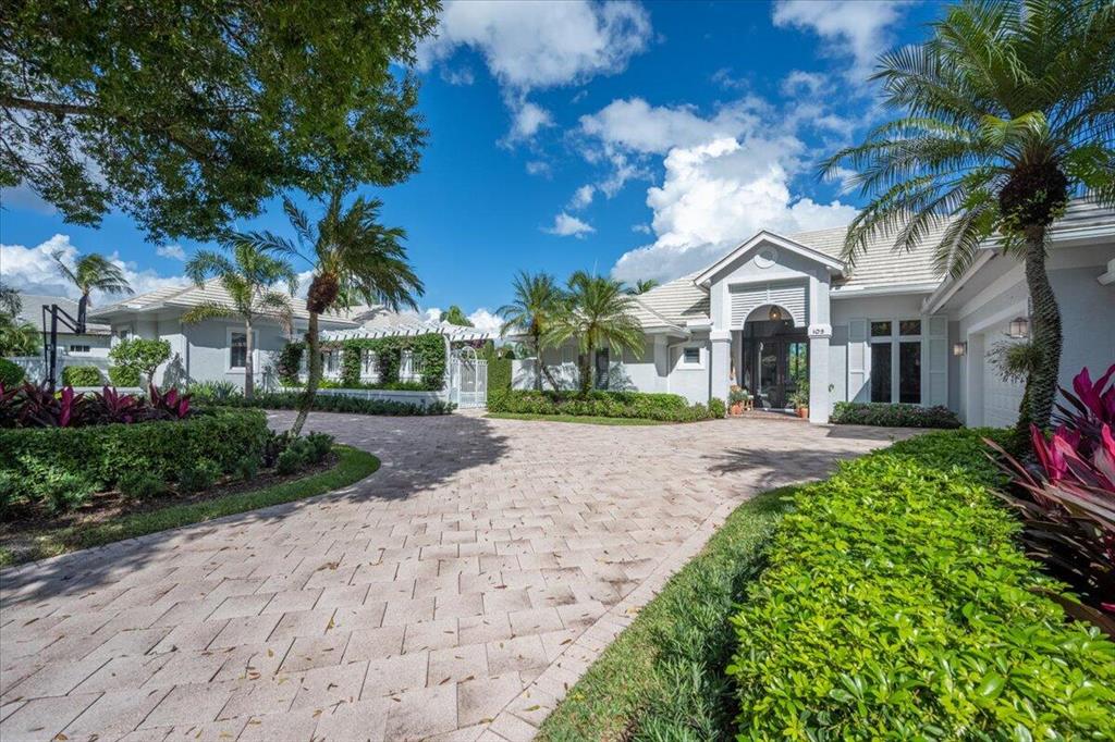 Completely renovated stunning family compound is located upon a double lot in the exclusive Loxahatchee Club. Situated on a .5+ acre lot, this home offers 4 bedrooms and 3.1 baths in the main house, 2 bedrooms and 2 baths in the guest house and an additional office/exercise/games room/home theatre building with a half bath and an adjacent putting green. All 3 buildings overlook an oversized resort style pool and patio area with lake views.  This home offers a clean, transitional decor with wood and marble flooring, masterful open kitchen with every detail in mind including the finest top of the line appliances as well as a Wolf gas range, impact resistant doors & windows, 2 tankless hot water systems, custom built cabinets & vanities,....no detail overlooked! This home is the ultimate for entertaining with an expansive outdoor living area with detailed summer kitchen, oversized swimming pool, and cypress ceilings on all patios and porches. Located in the heart of Jupiter and only minutes to the Jupiter Inlet and public beach access. The Loxahatchee Club offers 18-holes of Jack Nicklaus designed championship golf nestled amongst 285 homes and spread over 340 acres.