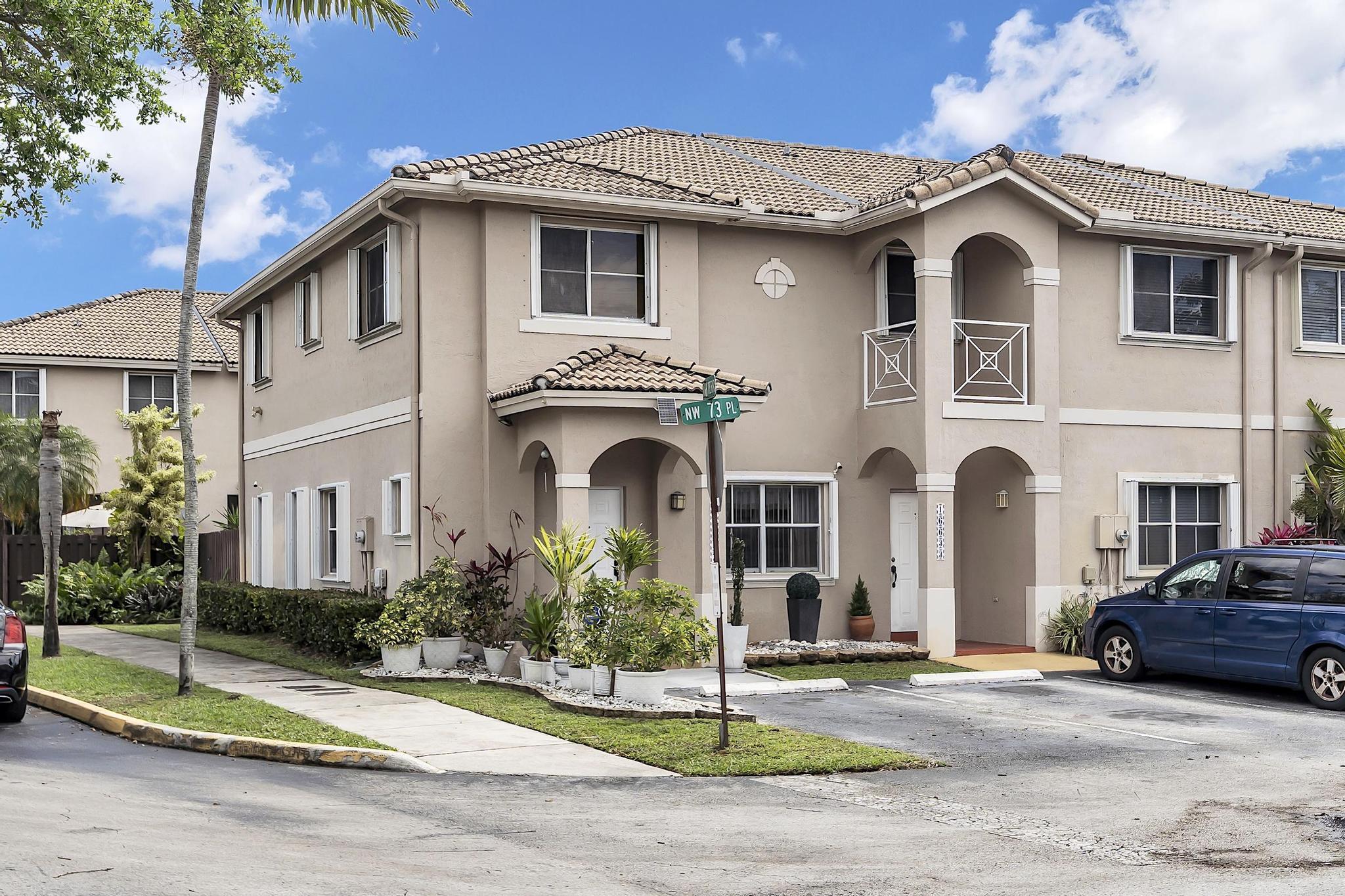 Spacious and bright corner townhome in the desirable Miami Lakes community, offering the feel of a single-family home with abundant natural light throughout. Features include tiled living areas on the first floor, gray wood flooring upstairs, and a modern kitchen with stainless steel appliances. Convenient 2nd floor washer/dryer location near the bedrooms. Hurricane shutters provide added protection and peace of mind. Enjoy enhanced privacy with green space alongside the property, two assigned parking spaces, and plenty of guest parking nearby. Community amenities include a pool and dog park. Low association fees and low property taxes make this an excellent opportunity for both homeowners and investors. Seller is open to assisting with a mortgage rate buy-down program for qualified buyers
