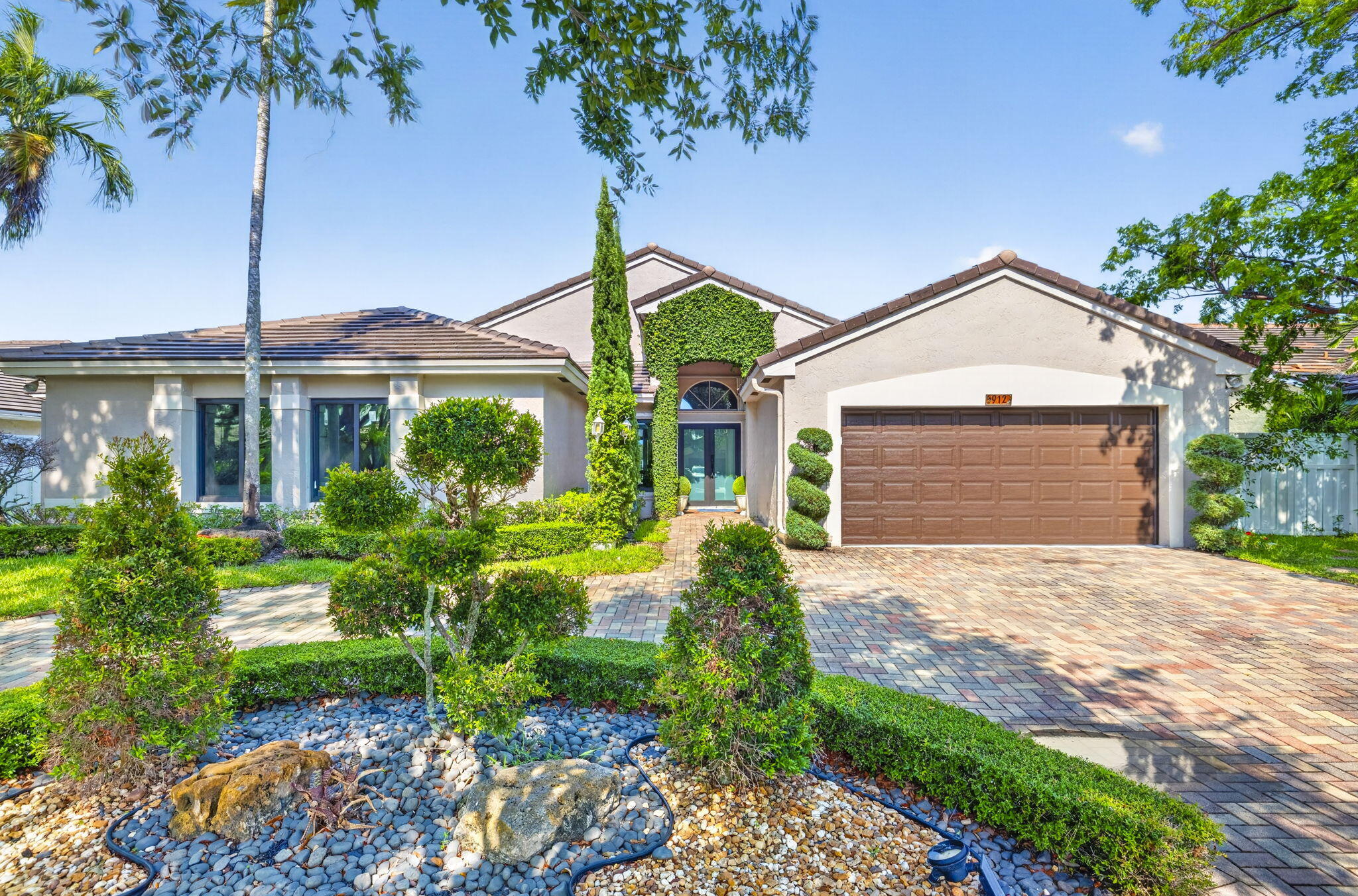 Rare opportunity to own a fully renovated waterfront home in a low HOA gated community. Extensive updates include a new flat tile roof (2026), impact windows and doors (2026), garage door (2026), updated appliances, HVAC (2022), and a Tesla charging station. The chef's kitchen features custom island, Italian cabinetry, and granite countertops. Porcelain flooring flows throughout the home. Enjoy South Florida living with a sparkling pool, expansive patio, and tranquil waterfront setting. Conveniently located near Sawgrass Mills, dining, entertainment, and great Schools.