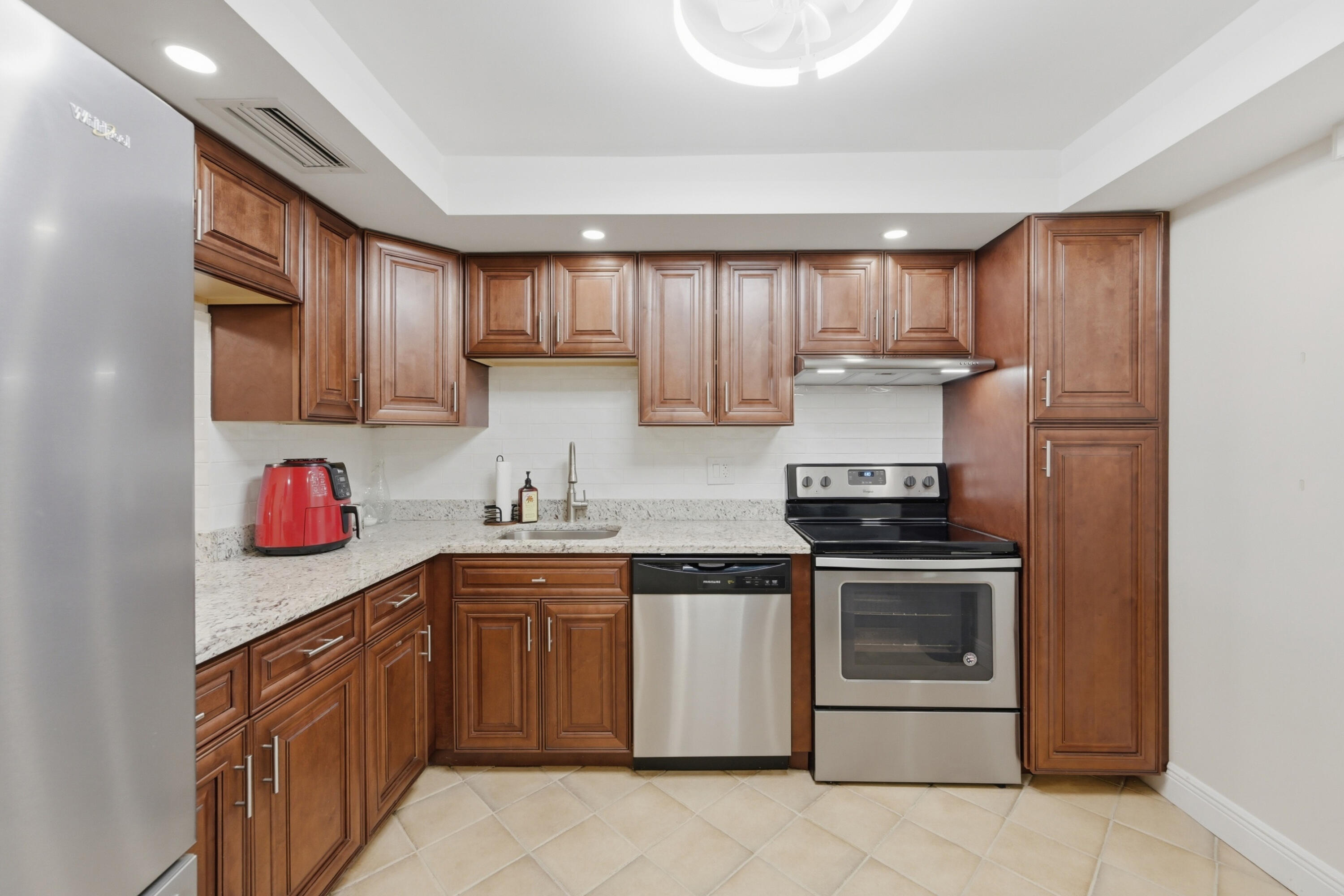 Hard-to-find ground-floor corner unit in Building 28 of Holiday Springs! Enjoy beautiful, expansive lake views from this ideally located residence. The interior features ceramic tile and laminate wood flooring throughout. The spacious primary bedroom offers sliding glass doors that open to a large screened patio with roll-down shutters—perfect for relaxing and taking in the serene waterfront setting. Washer and dryer are conveniently located inside the unit. Residents enjoy access to a vibrant clubhouse and two community pools. Don't miss this wonderful opportunity!