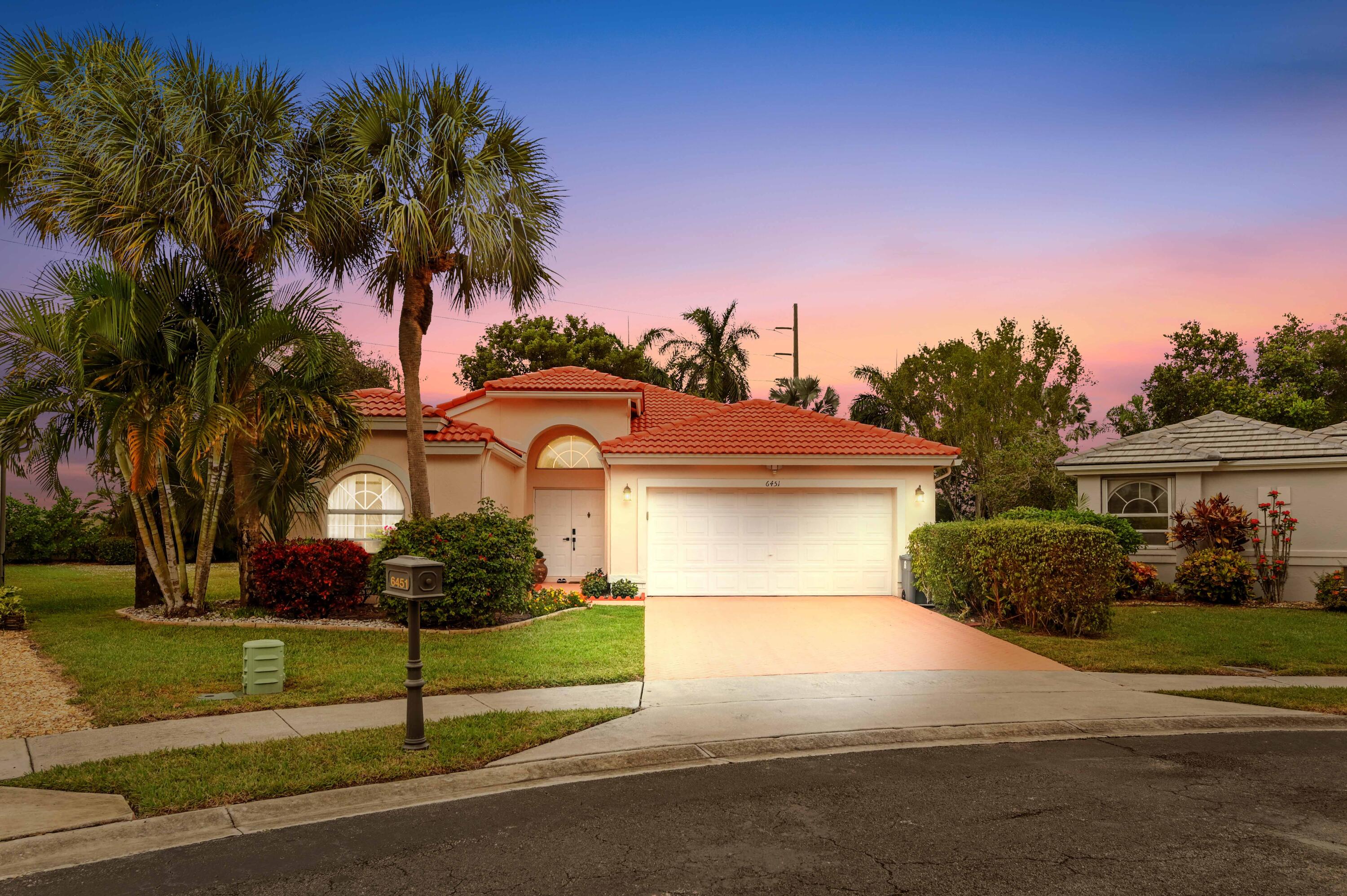Prepare to be captivated by this stunning single-family home, perfectly situated in the sought-after 55+ gated community of Coral Lakes! This residence offers an unmatched resort lifestyle with luxury amenities including a spectacular clubhouse, multiple pools, a state-of-the-art fitness center, a café, theater, tennis courts, card rooms, and vibrant social clubs. Step through the Grand Double Door Entrance into a bright, open split floor plan designed for effortless living. The interior is defined by vaulted ceilings and elegant recessed lighting. The heart of the home is the beautiful eat-in kitchen, which features sophisticated granite countertops with a waterfall island, custom wood cabinets, a large pantry, and a suite of stainless-steel appliances. The impressive Master Bedroom offers a private retreat, complete with a generous sitting area and two expansive walk-in closets. The ensuite master bath is a spa-like sanctuary with dual sink vanities, a relaxing soaking tub, and a glass shower.  The home is completed by a private, screened patio overlooking a quiet, lush tropical backyard, perfect for relaxation and entertaining. Practicality is assured with a two-car garage and a paver driveway. Located just minutes from fine dining, premiere shopping, the Turnpike, and I-95, this home offers the ultimate blend of luxury, convenience, and an active adult lifestyle.