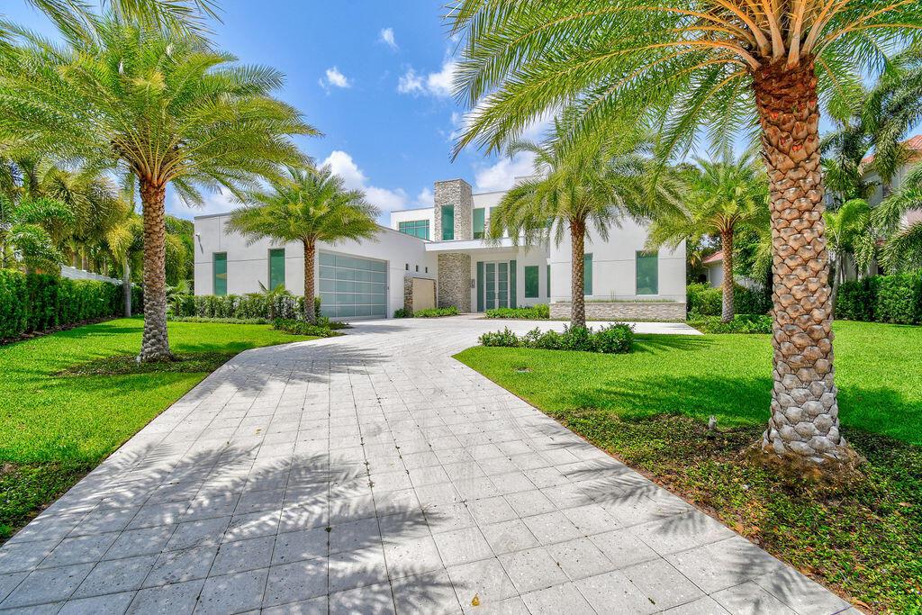 Introducing a newly 2021 built, modern inspired Intracoastal estate, highlighting sophisticated architecture. Superbly situated on an oversized homesite with captivating waterfront views in a no wake zone. Enter this grand, newly built residence to inhale the soaring ceilings, contemporary finishings & stunning pool & Intracoastal views. You will immediately be presented with an impeccable open floor concept, elegant entertaining space, an ultra modern kitchen with an abundantly large island, & floor to ceiling electric impact sliders that assist the view to go on & on. This residence has five bedrooms + office, seven bathrooms, a dramatically large pool/spa & fully equipped smart home. The primary suite is conveniently located on the first floor, as well as multiple guest en suites. Featuring a first & second floor laundry room & a sizable upstairs living area. Each upstairs ensuite will provide access to the graciously large terraces that overlook the outdoor scenery. All bedrooms have a walk in closet with built in custom shelving. In the side yard, you will find a private basketball court. In what seems like your own private park, enjoy gorgeous shading in the open & elongating backyard, under the mature Oak trees while overlooking premium water frontage. Here is your opportunity for an exquisitely customized estate on a charming street in a prime location!