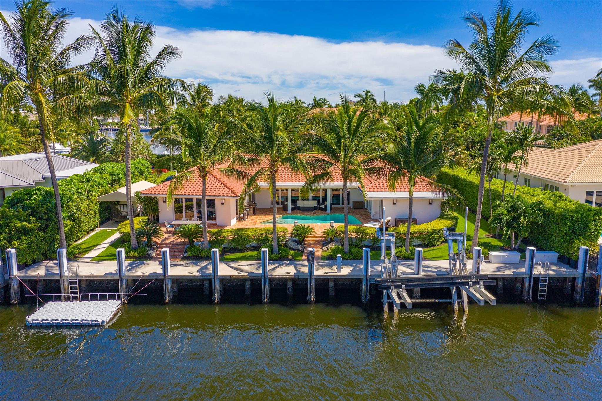Step into your exquisitely renovated waterfront haven, situated within the exclusive 24/7 security-patrolled yachting enclave of Harbor Beach. Inside, find elegant Bamboo flooring throughout complemented by soaring cathedral ceilings. This impeccably appointed residence boasts an array of features, including impact windows & doors, automated shades, & Lutron Smart Home system. The flawlessly designed kitchen is complete with a backlit Echo Glass island, GE appliances, & an electric stovetop, perfectly tailored to cullinary enthusiasts. Step out to your private outdoor oasis, where meticulously landscaped grounds surround a contemporary pool, a shaded seating area, & a newer seawall & dock, as well as a floating dock. This idyllic setting provides a serene backdrop for year-round enjoyment.