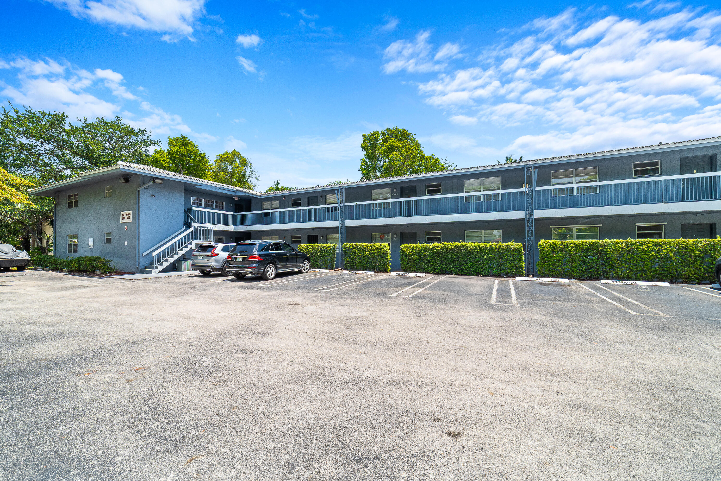 Welcome to the charming Oxford community in Coral Springs, where comfort, convenience, and a vibrant South Florida lifestyle come together. This well-maintained residence features a freshly painted exterior, attractive catwalk entry, one assigned parking space directly outside the unit, ample guest parking, and hurricane shutters for added peace of mind. Inside, you'll find spacious single-level living enhanced by stylish vinyl plank flooring throughout. The thoughtfully designed floor plan offers a formal dining area adjacent to the kitchen, which is appointed with stainless steel appliances, neutral finishes, and plenty of workspace for everyday living and entertaining.  The inviting living room is highlighted by a decorative fireplace with a hearth, creating a warm focal point for the space. Sliding doors lead to a private screened patio complete with additional storage, providing the perfect spot to enjoy Florida's year-round sunshine. This home also features two full bathrooms, including a primary bath with a built-in seating area in the shower, along with the convenience of a full-size washer and dryer located within the unit. Residents enjoy access to a community pool, grilling area, and gathering patio, ideal for relaxing or socializing with neighbors. Located near shopping, dining, parks, and everyday conveniences, this property is an excellent opportunity for a primary residence, seasonal retreat, or investment. Situated within an A-rated school district and surrounded by Coral Springs' abundant parks, recreational facilities, and community events, this welcoming city offers countless opportunities to create lasting memories and enjoy an exceptional quality of life.