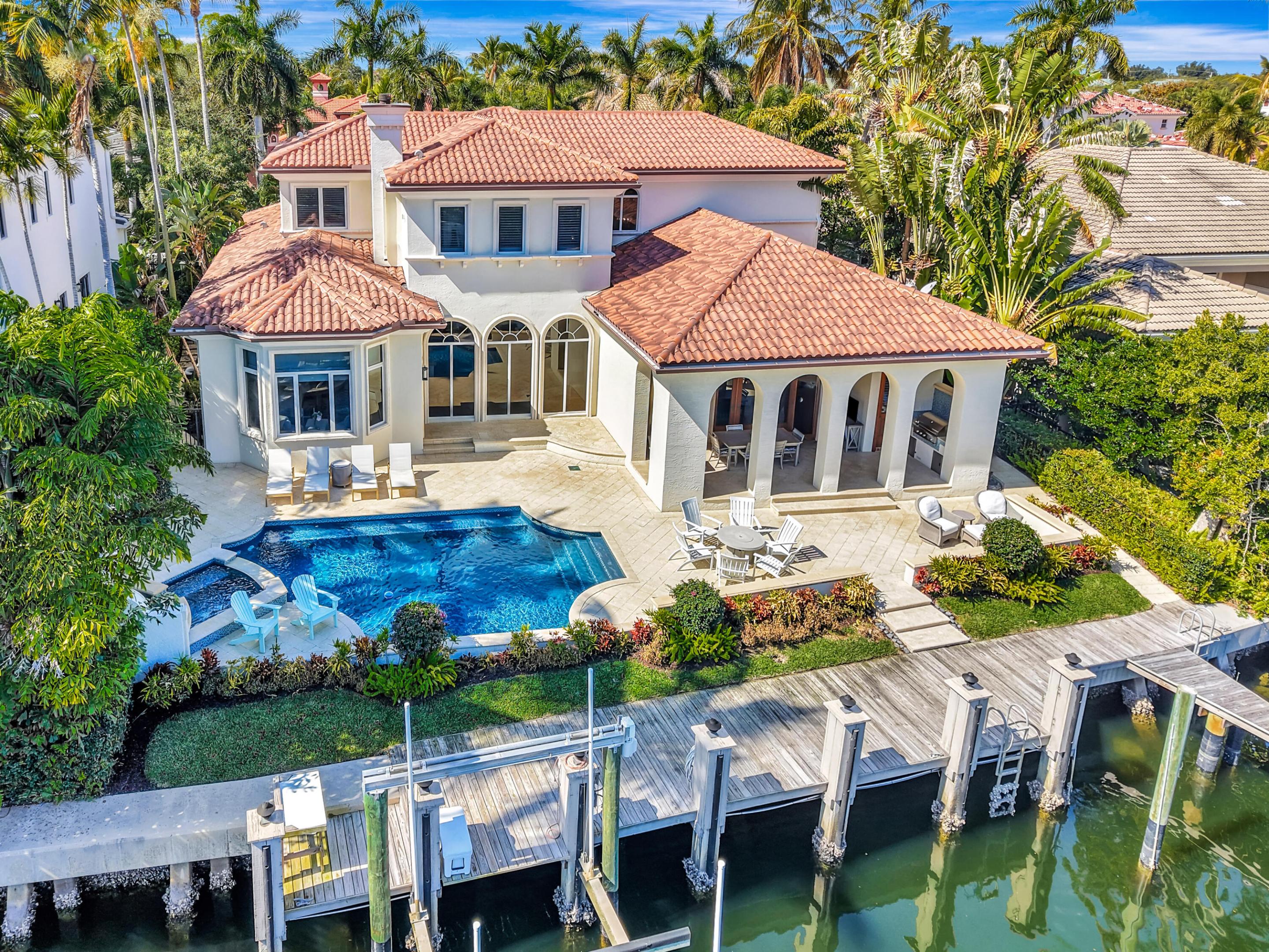 Welcome to 804 Harbour Isles Place, an exceptional waterfront residence in the highly coveted, man-gated enclave of Harbour Isles — a boutique community of just 100 homes where every property enjoys deep-water ocean access. With 90 feet of waterfrontage and concrete batter-pile seawalls throughout the community, this is boating at its finest.

Perfectly positioned with an east exposure, the home captures beautiful morning light and allows for comfortable enjoyment of the outdoor living spaces in the late afternoon — ideal for South Florida living.

Extensively renovated, the majority of the home was thoughtfully updated in 2023, including the pool, spa, and exterior enhancements. The first-floor interiors were curated by renowned local designer Niki Cavallo, delivering a refined yet welcoming aesthetic. A recently replaced roof adds to the home's value and peace of mind.

This four-bedroom residence features a first-floor primary suite, a private study, formal living room, and an inviting family room anchored by a cozy fireplace. Architectural details abound  a custom millwork package, rich hardwood floors, and nickel joint (shiplap) detailing throughout create warmth, texture, and timeless sophistication.

Each guest bedroom offers its own en-suite bath, ensuring comfort and privacy for family and visitors alike. In total, the home offers four full bathrooms plus two half baths  one serving as a convenient cabana bath for the pool and dock, and one for interior guests.

Outside, the renovated pool and spa complement the waterfront setting, while ample driveway parking enhances functionality for everyday living and entertaining.

Harbour Isles remains one of North Palm Beach's most desirable waterfront communities  low density, secure, and designed for those who value privacy, boating lifestyle, and quality construction.

This is a rare opportunity to own a beautifully renovated, designer-finished waterfront home with premier ocean access in one of the area's most exclusive gated neighborhoods.