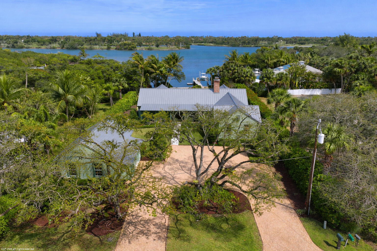 Enjoy relaxed waterfront living with sweeping Intracoastal views stretching across to Jupiter Island. Just a short walk to the beach, this property offers the perfect blend of coastal lifestyle and everyday convenience. Boaters will appreciate the private dock with boat lift.  The property features a spacious two-car garage with dedicated workspace and abundant storage, ideal for hobbies, gear, or extra organization. A screened-in porch provides the perfect spot to relax, entertain, or enjoy the breezes and scenery year-round. Built in 2017 and up to current building codes, the property offers the ability to expand with additional bedrooms or living space.