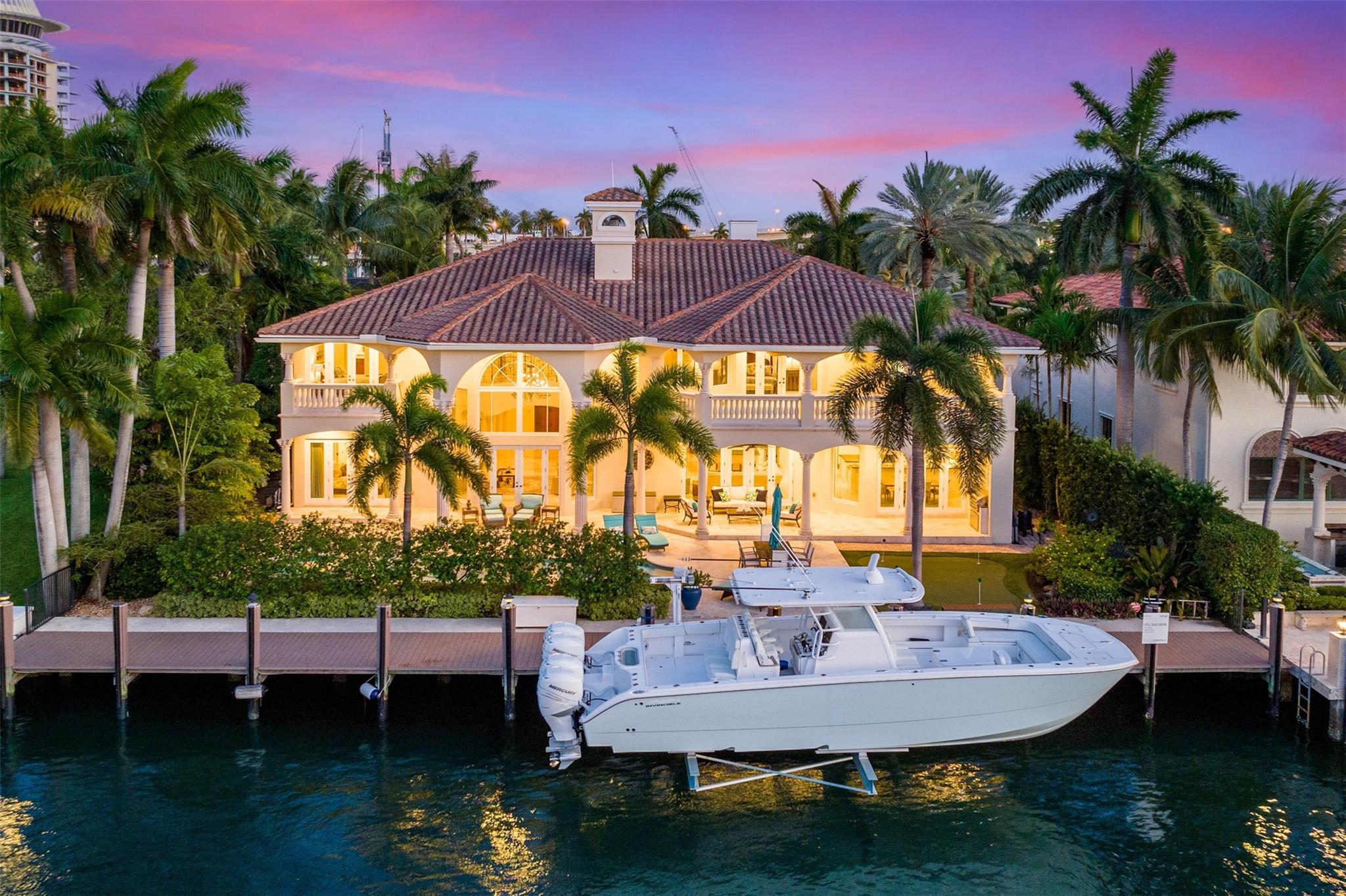 Introducing an exquisite waterfront estate nestled in the prestigious Harbor Beach gated community. This 7 bed/7.5 bath home situated just 4 homes from the Intracoastal w/ 100' WF offers quick ocean access. Inside, find a Great room w/ soaring ceilings & a grand fireplace. Updated chef's kitchen & bar seamlessly connects to family room. VIP Suite on 1st floor, oversized Primary suite, 2 junior suites + 2 en suite guest rooms provide ample accommodations. Additional office & gym plus elevator. Outside, find a covered patio w/ BBQ, heated pool, hot tub, & putting green. Recently installed 20Klb lift, upgraded AC's, & new wood flooring throughout. Private HB Beach Club membership available. Just minutes away from the beach, dining, & FTL airport.