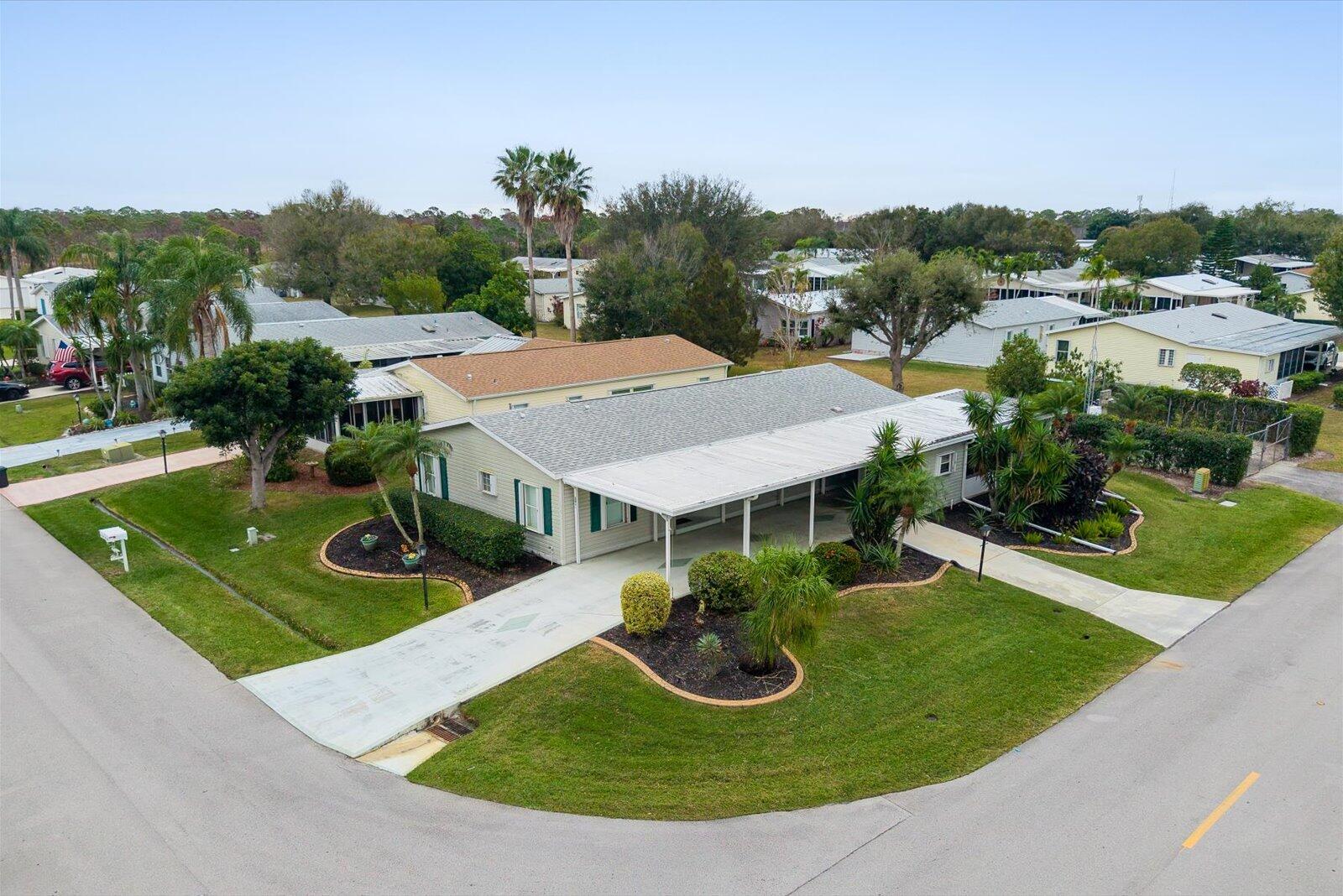 Welcome to your sunny slice of paradise in the Savanna Club 55+ community. This fun and flexible 2-BR, 2-BA home + a den/office sits on a corner lot and is packed with features to love. Enjoy an updated kitchen with SS appliances, split floor plan, plantation shutters along with tiled and laminate flooring. The enclosed glass lanai is perfect for morning coffee while TWO storage sheds and an additional driveway provide plenty of space for guests and parking. Home offers peace of mind with a 2020 roof, 2025 HWH, acc. shutters, irrigation well, and  partially furnished for your convenience. Just minutes from 2 clubhouses, a 10,000 SF theater, rec. center, 3 pools, restaurant, and endless activities you are sure to love this place so many call home! Land Lease Property