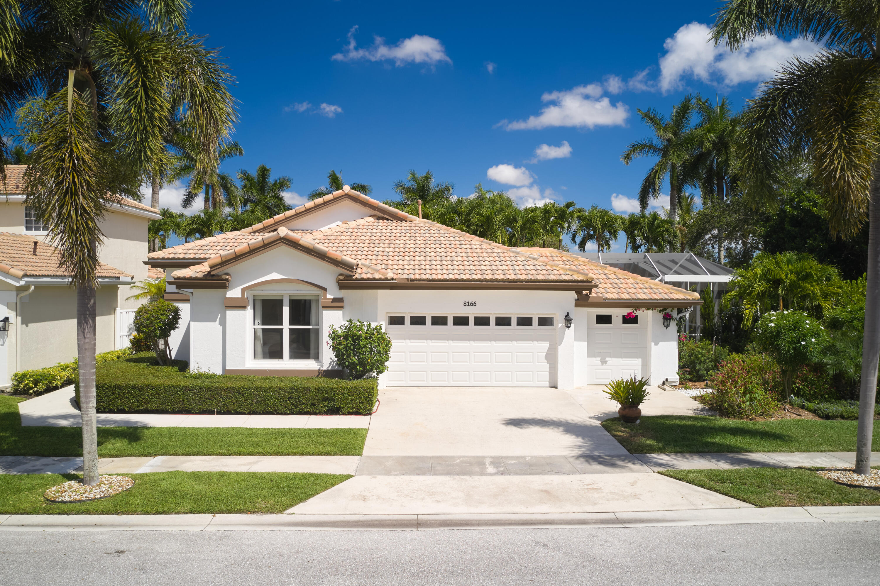 One of the most unique homes in the subdivision, this fully remodeled 3BR/2BA residence is the only property of its kind featuring a separate golf cart garage and an oversized lot large enough to accommodate a brand-new resort-style L-shaped pool - creating a level of outdoor living rarely found in the Quail Meadow community. Ideally located just steps from the clubhouse, the home offers a seamless blend of luxury, style, and functionality with warm modern finishes throughout, high ceilings, wide-plank oak-style flooring, custom architectural detailing, and exceptional indoor-outdoor flow. At the center of the home is a stunning open-concept kitchen showcasing floor-to-ceiling custom wood cabinetry, dramatic stone countertops, a massive waterfall island with integrated induction cooktop  and pop-up ventilation, double wall ovens, paneled appliances, and striking black slat accent walls that create a true designer feel. The spacious living and family rooms flow effortlessly to the covered lanai and screened outdoor entertaining areas through impact sliders and oversized windows that fill the home with natural light. The primary suite offers a relaxing retreat with a tray ceiling, custom accent wall, walk-in closet, and beautifully renovated spa-inspired bath featuring dual vanities, quartz countertops, a freestanding soaking tub, and a frameless glass shower with marble-look tile and brass fixtures. Guest rooms are equally inviting with thoughtfully designed finishes and comfortable layouts. The outdoor living space was designed for entertaining, featuring an expansive screened patio, oversized pool deck, covered dining and lounge areas, lush tropical landscaping, and the striking newly added L-shaped pool with clean modern lines and in-water seating as the centerpiece. A truly special opportunity offering designer-level finishes, exceptional outdoor living, and one of the most distinctive layouts and lot configurations within the community.