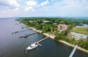 Discover this ultra-custom wide waterfront luxury home in prestigious South Sewalls Point!''Smart'' home designed by Kelly & Kelly Architects! Creston system controls the extensive electronics throughout the home! 3 levels with waterfront patios on all 3! Gourmet kitchen with Wolf, Sub Zero & Miele SS appliances & oversized pantry! Huge lower level man cave/family room! Marble, wood, stone, granite, onyx surfaces throughout home! Wood beamed ceilings! Impact glass, 9.5ft arched French doors, retractable screens on ground floor patio! Exercise room! Air conditioned garage! gated! full house generator! 1000 gallon propane 5 ft water depth @ dock, currently  harbors a 50 ft boat! Be prepared to fall in love with this magnificent home!