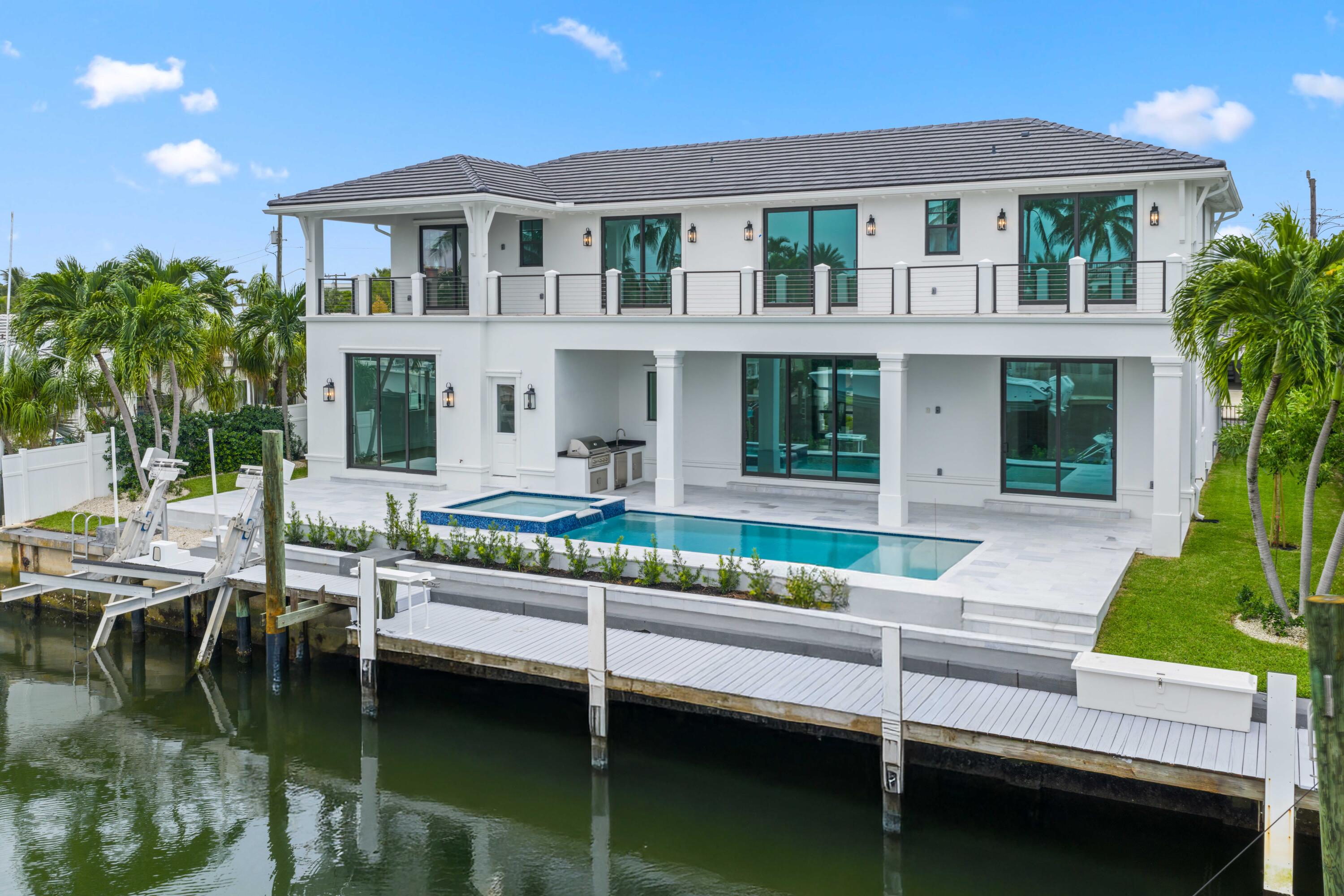 Waterfront New Construction! 5BR, one of which could serve as an Office, 6.1 BA, 2CG CBS home built with the finest and most Luxurious finishes (Floor Plans Attached). 90' of water frontage on a deep wide water canal. New 74' dock and 15k lb lift. Ocean access within minutes with no fixed bridges and a short walk to the beach. Abundant living space including great room, family room, formal dining room and dual master suites. 12'x35' heated pool/spa with large sundeck. A dream gourmet kitchen offers a Thermador 6 burner sealed Gas stainless steel cooktop, Thermador stainless steel 30'' built in double convection ovens, Thermador 48'' fridge/freezer, dual Thermador dishwashers, microwave oven and a spacious pantry. The kitchen features - See Supplement... The kitchen features hand-made custom cabinets with a large island. This home offers a grand entrance with double bronze aluminum/glass doors & marble floors and beautiful staircase leading to a gallery opening to a deck on the front of the house. The living areas on both floors are finished with high quality engineered wood floors. Several rooms feature beautiful ceiling details. The home is built with the best quality materials and workmanship including high impact hurricane windows and doors. There are large sliding doors in all the rooms facing the water letting in lots of natural light and giving a beautiful view of the pool, the water and your boat. The house is perfect for entertaining with a wonderful flow from the indoors to the outdoors.

The downstairs master suite includes oversized his & her closets, a spacious bathroom with a built-in dressing table, dual shower, soaking tub, and separate toilet rooms all finished in the highest quality marble floor and Snow White marble counter tops. The upstairs boasts a spacious master suite with a large deck the full width of the house overlooking the pool and the water. Three additional upstairs bedrooms are all ensuites with luxury finishes and large walk-in closets also open out to the deck. The deck has a 14'X19' covered area. There is a day kitchen with sink and refrigerator in the gallery. Additional features include a large veranda with summer kitchen and cabana bath. This home is architect designed and has a West Indies flare with many contemporary features and includes new lush tropical landscaping. No furnishings, window treatments, light fixtures (except those already installed) or built-ins are included in the sale price.