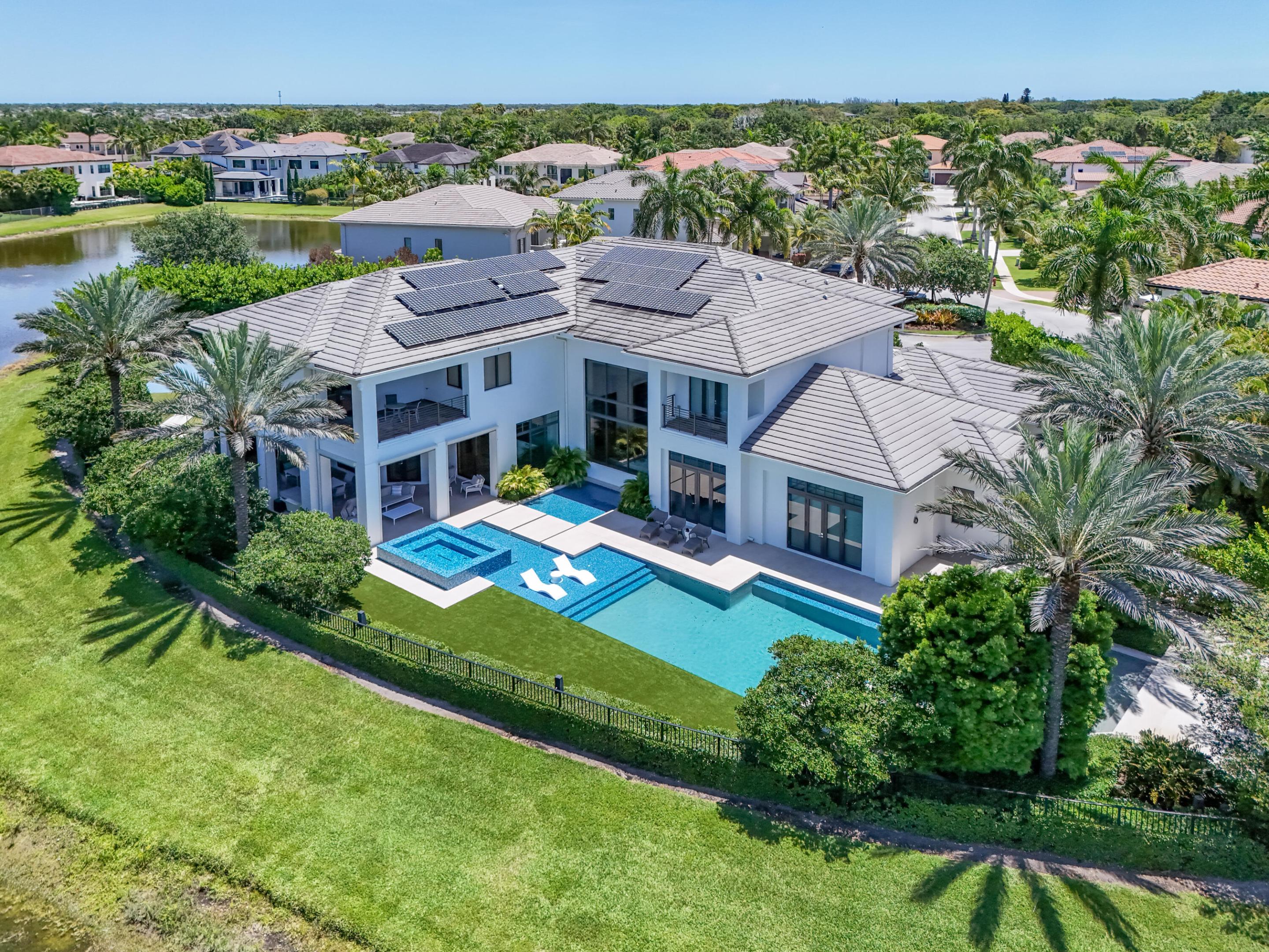 9105 Pintura Way is a completely renovated masterpiece quietly tucked away at the end of a cul-de-sac on a spectacular 1/2 acre lakefront lot in The Oaks.  This 8,500-square-foot estate is fully furnished with an uncompromising focus on design, entertainment, comfort, and security. The home offers 5 bedrooms, 6.5 baths, two private studies, a custom movie theater, soundproof wine room, elevator, upstairs and downstairs laundry rooms, mudroom, and a five-car garage which includes a golf cart garage and hydraulic autostacker. From the moment you enter, the home makes a dramatic statement with soaring ceilings, expansive open living spaces, bespoke architectural detailing, and a stunning custom curved glass staircase anchoring the interior. Designed for both everyday living and large-scale entertaining, the chef's kitchen is outfitted entirely with top-tier Sub-Zero, Wolf, and Miele appliances including double refrigeration, freezer drawers, warming drawer, built-in coffee and steam systems, ice machine, and a fully customized outdoor kitchen with a commercial-grade Hood Depot ventilation system designed for true outdoor culinary performance.    The custom JBL Synthesis certified theater was designed for a true cinematic experience, featuring Atmos ceiling speakers, a top-of-the-line Sony laser projector, professional acoustic insulation, reinforced concrete construction, and hidden storage — all engineered to create an immersive, fully deadened sound environment rarely found in a private residence.    The backyard is truly world class — featuring a spectacular pool and spa, expansive entertaining areas, outdoor kitchen, basketball court with commercial lighting for evening play, in-ground trampoline, lush landscaping, and pre-wired for a future hydraulic outdoor television viewing system designed for major sporting events and outdoor entertaining.    What truly separates this home is the extraordinary level of infrastructure and technology integrated throughout the property. The residence features complete Savant home automation, Lutron lighting, iAquaLink pool systems, Araknis professional-grade networking, whole-home distributed audio, motorized shades, remote Bluetooth-controlled entry systems, a dedicated climate-controlled rack room, dual NVR-supported CCTV security system with over 20 cameras, hardwired office systems for enhanced security, and a massive 70kW whole-home Generac generator capable of powering the entire estate.    Additional upgrades include 600-amp electrical service, 15 independently controlled Nest HVAC zones with dampeners in every room, Navien tankless water heaters, Icynene spray foam insulation, whole-home water filtration with multiple reverse osmosis systems, custom exterior lighting by Illumination, drip irrigation throughout the rear grounds, Level 2 EV charging stations, reinforced storage and vault areas, and a soundproof concrete wine room engineered to also function as a secure safe room, listening lounge, or private retreat.