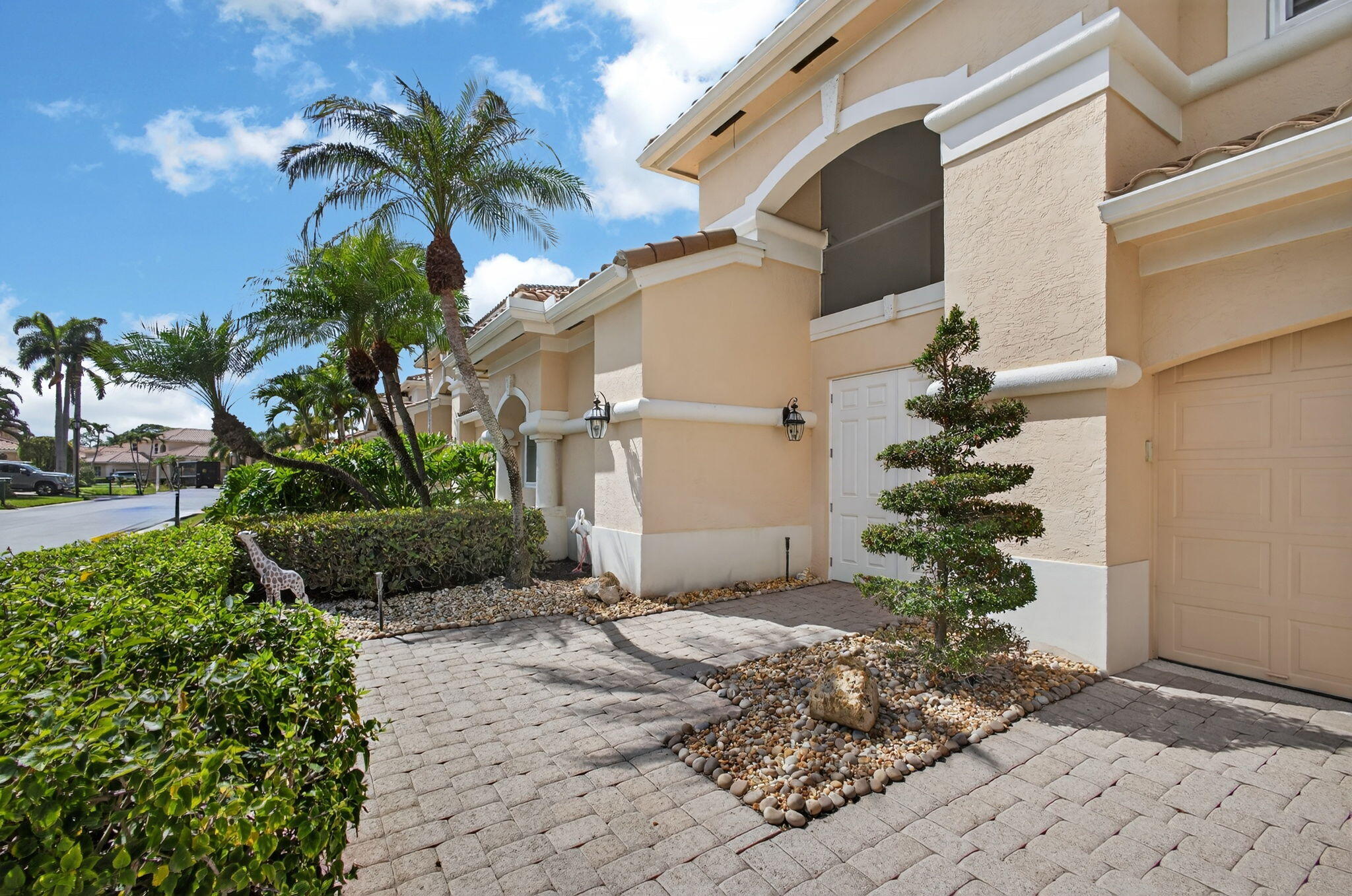 Stunning residence overlooking the 16th hole of the Champion Golf Course in the exclusive Grand Cay community at PGA National. This fully upgraded and meticulously maintained home features a private pool house with covered porch and waterfall feature. High-quality impact windows and doors are installed throughout, along with custom electric blinds and automatic awnings. Interior highlights include a Dimplex electric fireplace, custom built-in dressers and end tables, designer lighting, a beautiful custom kitchen island, and a top-of-the-line Kutch electric stove. Exceptional craftsmanship and refined finishes define this golf course property.