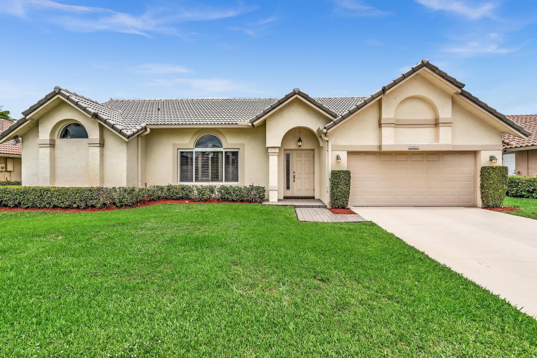 Welcome to this charming  beautifully maintained 4 -bedrm, 2-bathrm single-story residence PLUS- Functional Air Conditioned Florida rm in Boca Greens. The Open Kitchen concept is located in a Generously Spaced Great Rm, w/ Vaulted Ceilings, Dining Rm & Breakfast Nook, Wood Cabinetry  Kit. Cabinets, granite countertops & Stainless Steel appliances. Primary bdrm large enough to fit a King size bed, Dual Nightstands & Dresser with out feeling cramped. The Split floor plan contains 3 generously sized bdrms. Impact glass for peace of mind. 2-car garage adds convenient parking & storage options. This single-family residence combines practical layout making it an excellent choice for those seeking to live in a tranquil established community. Centrally located, Room for Pool,Guard Gated, Low HOA.