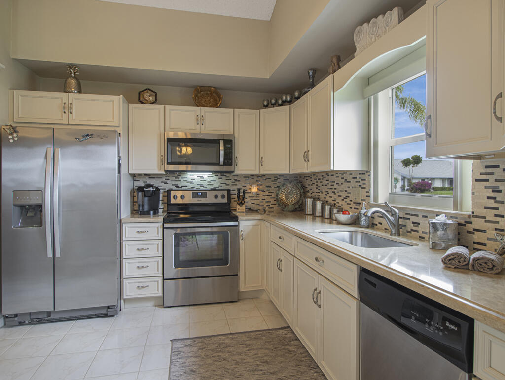 55+ - Beautifully maintained 2BD/2BA townhome on a desirable corner lot in Cypress Lakes, an active 55+ community in the heart of West Palm Beach! This move-in ready home features vaulted ceilings and extensive updates throughout. Major improvements include a new roof (2019), A/C (2022), water heater (2019), hurricane impact front door (2022), hurricane impact windows (2023), and freshly painted exterior (2025) for added peace of mind and energy efficiency. The kitchen was updated in 2017 and both bathrooms were tastefully renovated in 2020 and 2023. Additional upgrades include new washer and dryer (2026), garbage disposal (2022), garage concrete floor coating (2022), vertical blinds (2018), freshly painted driveway (2025), and professionally cleaned, sealed, and refreshed tile and grout.
