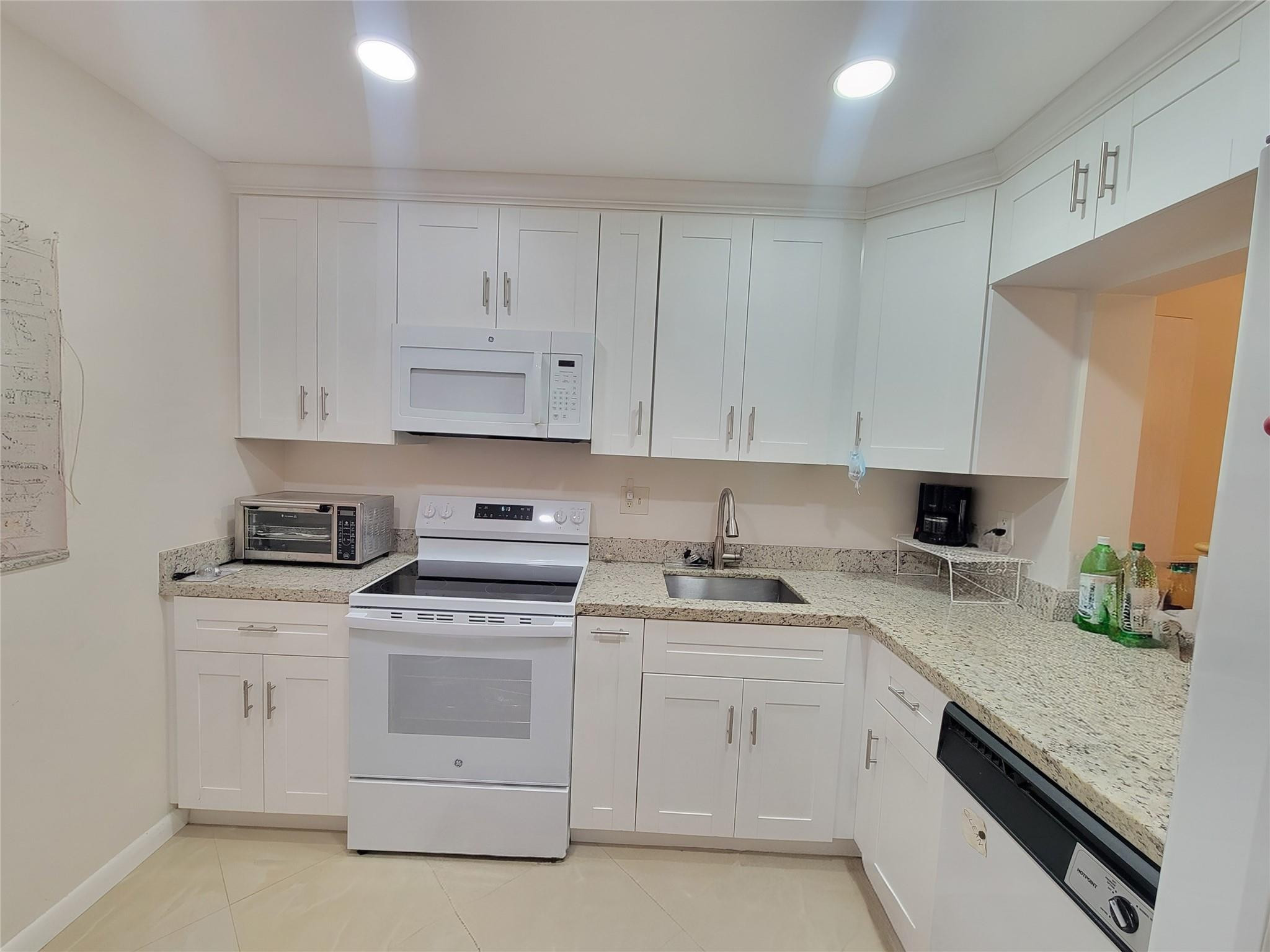 Beautifully remodeled 2/2 condo unit located on the 1st floor. This open-concept 1090 sq. ft. home features new white kitchen with soft close drawers, quartz counters with 20x20 porcelain tiles throughout unit including enclosed porch. Master bedroom with walk in closet, master bath has shower & bath. Impact windows & impact door. Upgraded electrical panel. Low HOA fee $339 monthly. Lots of guest parking. 55+ community.  Waterbridge 4 allows rental after first year of ownership.