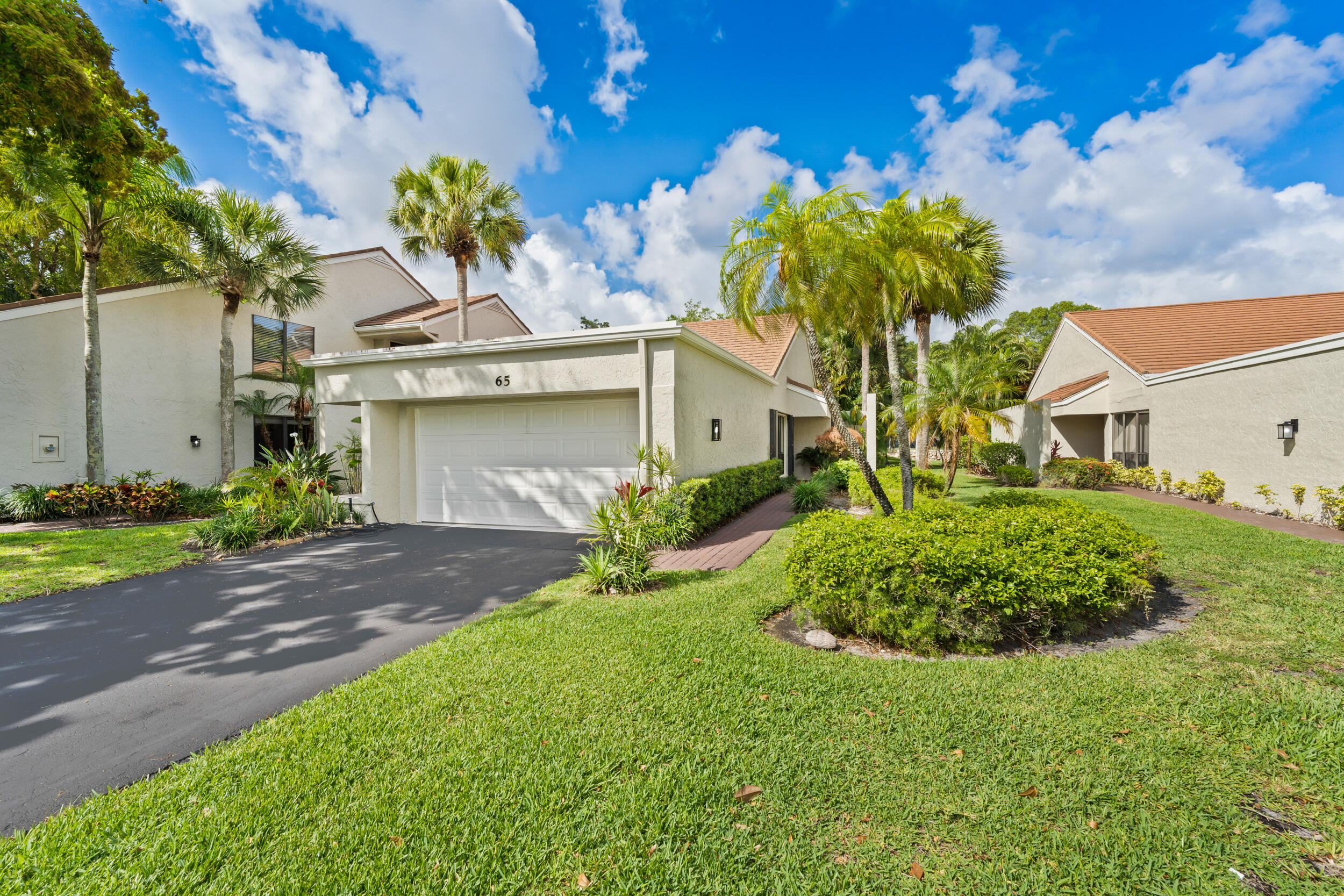 Nestled within the prestigious PGA National community, this beautifully updated residence is a 2 bed/2bath + Den. The remodeled kitchen opens to bright living spaces featuring new vinyl flooring (2026) and abundant natural light. Enjoy major improvements including high-impact windows and sliding glass doors (2019), hurricane shutters, screened enclosure (2019), new A/C unit (2026), and UV light mold mitigation system in the ductwork. The guest bathroom was fully renovated in 2026 with a new vanity, mirror, toilet, shower, and drain assembly, while the primary bath features a newly tiled shower with updated hardware and glass enclosure. Move-in ready and ideally located near world-class golf, dining, shopping, and amenities.