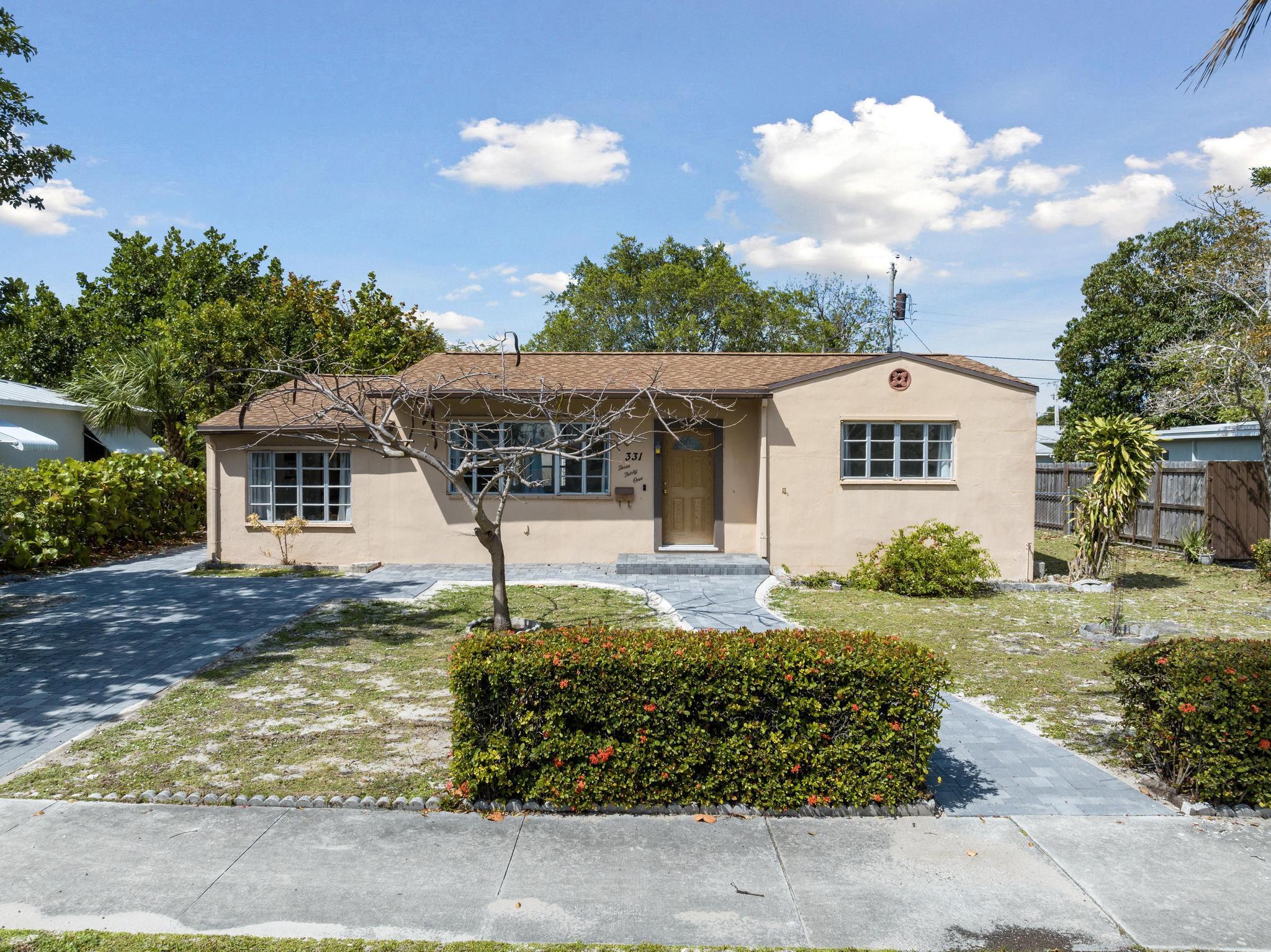 Welcome to this inviting 3-bedroom, 2-bathroom home featuring terrazzo floors throughout, an updated kitchen with modern gray cabinets, quartz countertops, along with an open floor plan. Modern barn doors in the primary bedroom add character, while the primary bathroom offers a convenient walk-in shower. Relax in the Florida Room or enjoy outdoor gatherings on the patio. Conveniently located minutes away from downtown West Palm Beach, local shops, restaurants, and the Intracoastal.