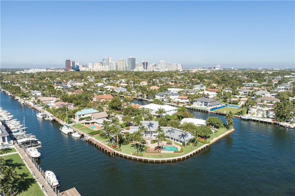 IT'S ALL ABOUT THE LOCATION AND VIEWS...  Experience the wow factor from this Intracoastal point lot with breathtaking waterway views and a daily parade of yachts. Ideal for the avid yachtsman with 313 feet of deep water frontage, no fixed bridges and only minutes to the inlet and Atlantic Ocean. Large square footage, volume ceilings & Intracoastal views from almost every room make this home ideal for entertaining. Guest Quarters above the 3 car garage is perfect for your boat captain or private home office. Square footage from IMAPP.