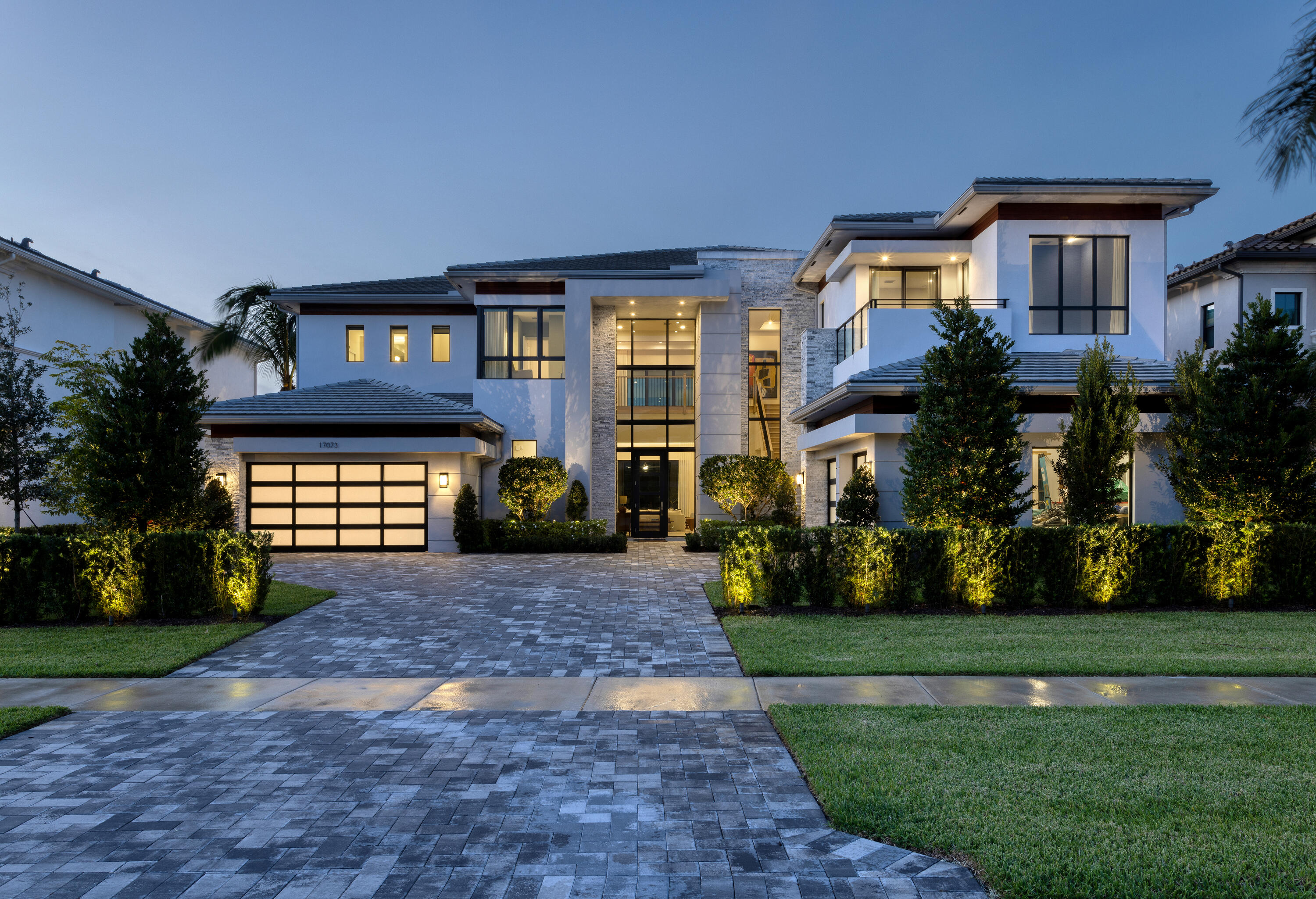 This Vanderbilt Grand model, the largest offered in Boca Bridges, was constructed by the illustrious GL Homes in 2022. With 8,101± square feet of luxurious living space, this majestic residence boasts six spacious bedrooms, eight bathrooms, four-car garage, custom and upgraded accents, luxurious millwork, resort-style pool, and opulent outdoor living area. A fully furnished option is negotiable for this sprawling estate. This estate's verdant greenery and breathtaking views of the nature preserve, and shimmering lake exude tranquility and peace. The modern residence features immaculately landscaped exteriors with exquisite split-face crystalline marble stone siding details, sandstone pool deck pavers, and custom patio ceiling millwork.  

Surrounded by lush Areca Palms, the estate's lavish outdoor entertaining space comprises an oversized resort-style pool, waterfall spa, and customized summer kitchen, creating an idyllic and private tropical oasis.  

Bedecked with custom accents such as imported Brazilian Jade countertops, stylish oversized mud set porcelain floors, double wine refrigerator, floor-to-ceiling white oak built-ins, tambour millwork detailing, Sonos sound systems, and backlit floating soffit ceilings, this stunning estate impresses at every turn.  

Extending from the foyer, the open-concept living room offers an unobstructed view of the estate's spacious backyard, resort-style pool, picturesque lake, and natural preserve through the expansive PGT impact sliders and windows. 

The ultra-chic kitchen boasts elegant two-inch quartz waterfall countertops, complemented by designer cabinetry with concealed matching industrial hood. The kitchen is equipped with top-tier appliances, including a Sub-Zero refrigerator, custom built-in eight-burner Wolf range with griddle and stacked ovens, and dual Bosch dishwashers. 

The dining room is adorned with designer wallpaper and boasts large windows that invite an abundance of natural light into the space. Additionally, the first floor also includes one ensuite guest bedroom, open concept family room, theater and an opulent spacious lounge.  

A white oak banister leads to the residence's second floor which features wide plank white oak wood floors spanning the capacious loft space, which opens to a peaceful balcony. 

The primary suite boasts a chic white oak wet bar, custom dual outfitted walk-in closets, spacious sitting area, and a private patio overlooking the estate's striking and serene outdoor space. The primary suite's commodious bathrooms feature white oak and high gloss cabinetry, regal three-inch quartz countertops, frameless showers, and freestanding Hydro System tub.  

The second floor features the residence's laundry room and four remaining ensuite guest bedrooms, each expertly designed with custom linen textured wallpaper and customized walk-in closets. The guest suite also features contemporary wood veneer wallpaper and a private balcony.  

DISCLAIMER: Information published or otherwise provided by the listing company and its representatives including but not limited to prices, measurements, square footages, lot sizes, calculations, statistics, and videos are deemed reliable but are not guaranteed and are subject to errors, omissions or changes without notice. All such information should be independently verified by any prospective purchaser or seller. Parties should perform their own due diligence to verify such information prior to a sale or listing. Listing company expressly disclaims any warranty or representation regarding such information. Prices published are either list price, sold price, and/or last asking price. The listing company participates in the Multiple Listing Service and IDX. The properties published as listed and sold are not necessarily exclusive to listing company and may be listed or have sold with other members of the Multiple Listing Service. Transactions where listing company represented both buyers and sellers are calculated as two sales. Some affiliations may not be applicable to certain geographic areas. If your property is currently listed with another broker, please disregard any solicitation for services. Information published or otherwise provided by seller, listing company or its representatives is deemed reliable but are not guaranteed and subject to errors, omissions, or changes without notice. Copyright 2024 by the listing company. All Rights Reserved.