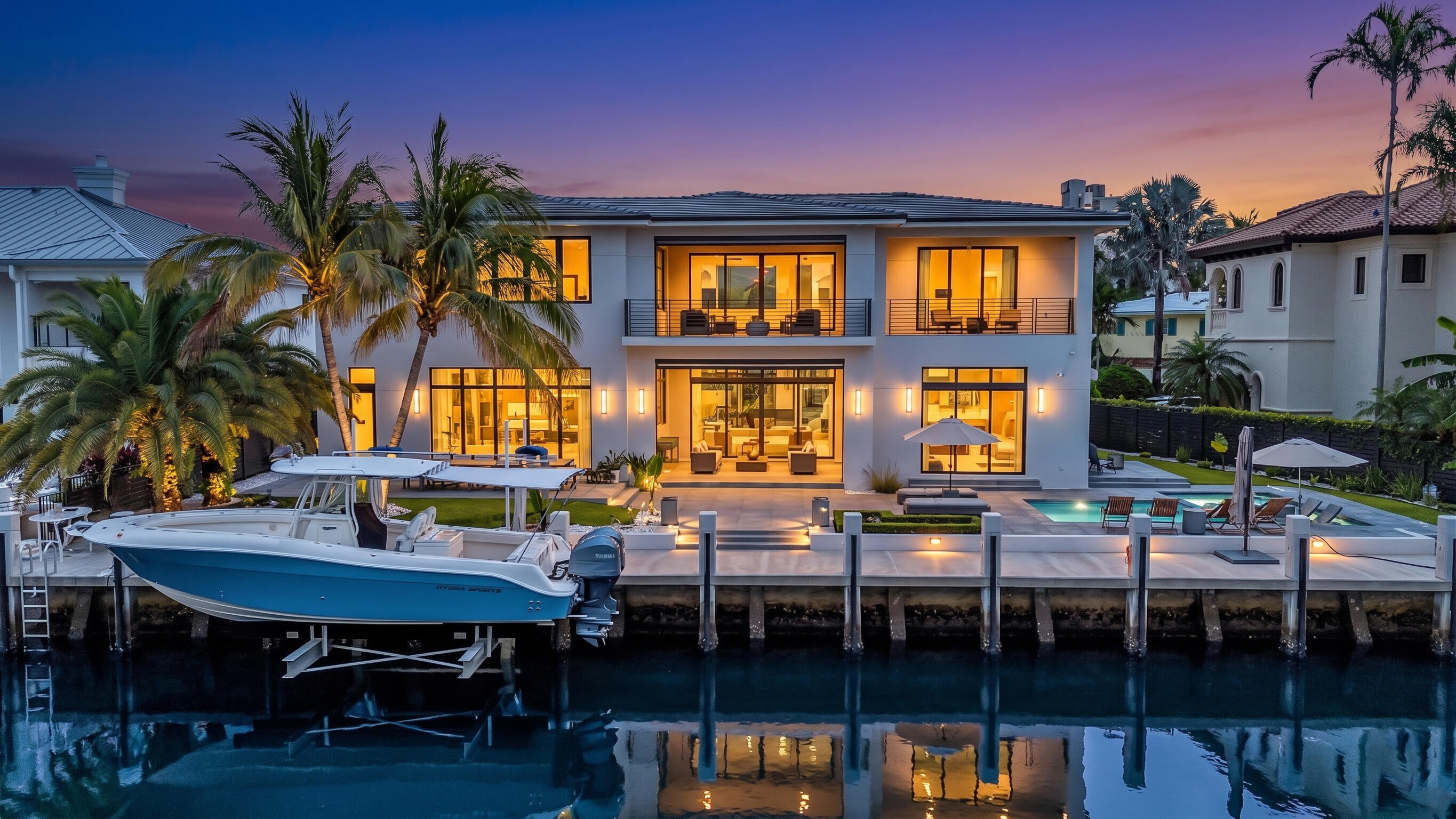 Experience the pinnacle of South Florida waterfront living in this exceptional brand-new construction estate boasting 116 feet of deep-water frontage and a newly constructed concrete dock complete with a 25,000-pound boat lift. Designed for the discerning boater and entertainer alike, this residence offers seamless access to open waterways while delivering uncompromising luxury throughout. Upon entry, soaring 22 to 24-foot volume ceilings create a dramatic first impression, complemented by expansive walls of glass, fully retractable sliding doors, and sophisticated West Elm-inspired designer finishes. The home is equipped with Control4 smart-home automation, Sonos whole-home audio, security cameras, flush-mounted A/C vents, impact glass throughout, and custom-built closet systems in every room. The chef's kitchen showcases premium Sub-Zero refrigeration, a Sub-Zero wine cooler, Wolf induction cooktop, and Wolf double wall ovens. The luxurious primary suite serves as a private retreat featuring dedicated shoe, clothing, and linen closets along with a spa-inspired bath offering a freestanding soaking tub and oversized double shower. A secondary primary suite with en-suite bath provides ideal accommodations for guests or multigenerational living. Outdoor living is elevated with a resort-style saltwater pool, integrated sun shelf, spa, cabana bath, retractable Sunsetter shade system, faux wood ceiling details, and a second-story balcony pre-plumbed for a future wet bar. Built with steel beam reinforced CBS construction, three-zone air conditioning, dual hybrid water heaters with storage tanks, French drain systems, and extensive marine-grade waterfront infrastructure including a PVC seawall cap and substantial piling foundation, this residence was thoughtfully designed for both luxury and longevity. A rare opportunity to own a newly completed waterfront masterpiece where cutting-edge technology, superior construction, and exceptional boating amenities come together in one extraordinary offering.