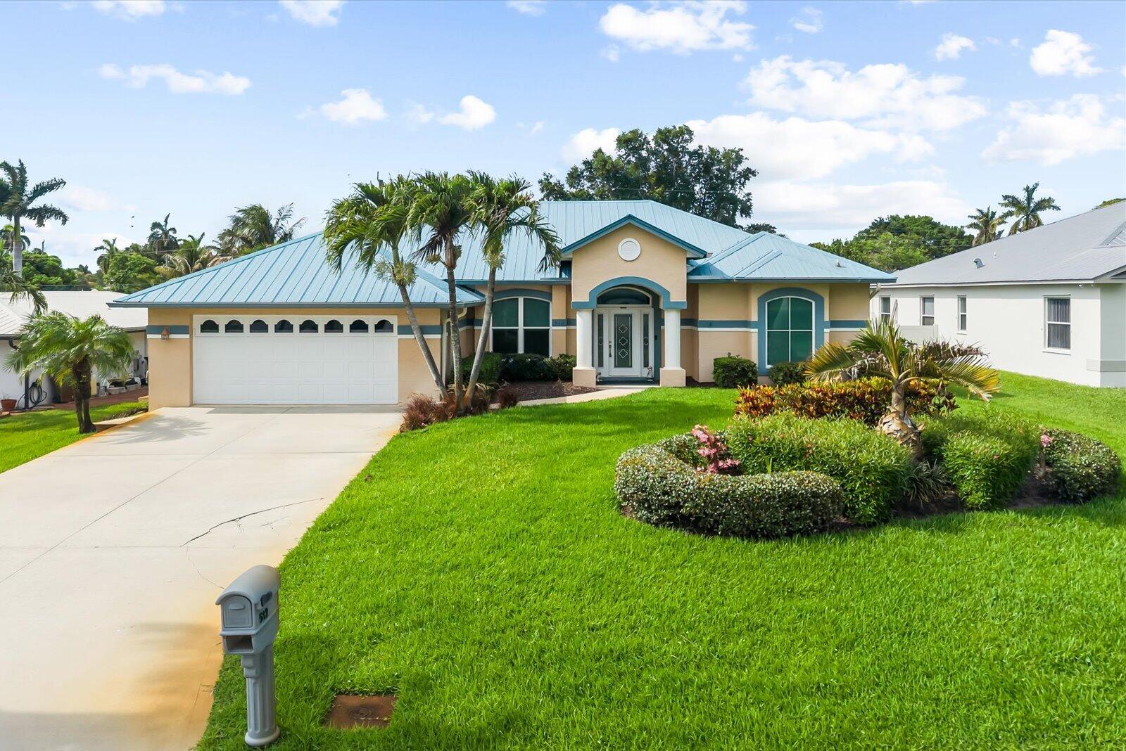 Beautifully maintained waterfront home situated on a deep-water canal, offering the perfect blend of comfort, style, and exceptional outdoor living. This 3-bedroom, 3-bath residence features luxury laminate flooring, remodeled bathrooms with a relaxing Jacuzzi tub, hurricane-impact windows and sliders, remote blinds, a custom built-in office wall unit, and a hard-wired generator for added peace of mind. Spacious living areas and a separate water filtration system provide everyday convenience. Enjoy your private backyard oasis with a heated pool, screened-in lanai, 90' bulkhead, tiki bar, boat lift, and in-ground sprinkler system. Additional highlights include a durable metal roof approximately 7 years old and pride of ownership throughout.