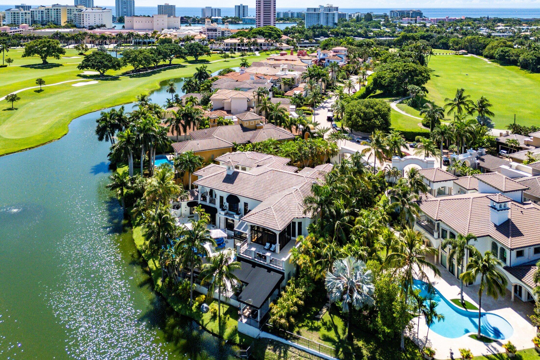A Masterpiece Within the Iconic Grounds of The Boca Raton. Set behind the gates of the ultra-exclusive Mizner Lake Estates, nestled within the iconic grounds of The Boca Raton Hotel & Club, this extraordinary estate is a masterclass in timeless luxury and architectural sophistication. Encompassing 8,125 square feet under air and 11,285 total square feet, the residence overlooks  a lake and renowned championship golf course. Designed for effortless entertaining and refined everyday living, the resort-style outdoor retreat centers around an infinity-edge, sun-drenched pool with a sunken bar and in-water stools. The expansive summer kitchen features a 50-foot bar, built-in grill, and commercial-grade ice maker. Numerous covered lounge areas with motorized overhang awnings provide comfort and shade, while a private lakefront overhang delivers mesmerizing views of the 8th green. Every element has been curated to take full advantage of the breathtaking water and golf course vistas. Inside, the home is equally impressive. The gourmet kitchen is a culinary dream, outfitted with top-of-the-line appliances, a large walk-in pantry, and a separate butler's pantry. A custom hand-crafted hidden door reveals the formal dining room a striking architectural feature that adds a sense of intrigue and design pedigree. The estate features five bedrooms and seven and a half baths, including a showstopping primary suite with dual spa-style baths and boutique-style closets for the ultimate private sanctuary. Included in the bedroom count is a detached guest house as well as a private-entry suite with balcony access perfect for hosting guests or multi-generational living. A richly appointed home office, with its own ensuite bathroom, completes the versatile layout. An attached, oversized three-car garage offers air-conditioned comfort and ample room for luxury vehicles and storage. A separate, detached, fourth garage, also air-conditioned, provides additional flexibility with space ideal for a home gym, private office, or workshop. Every element of this estate has been thoughtfully curated to deliver an unparalleled lifestyle experience in one of Boca Raton's most prestigious enclaves. Seller has updated home to a smart home and the home has a full house generator.